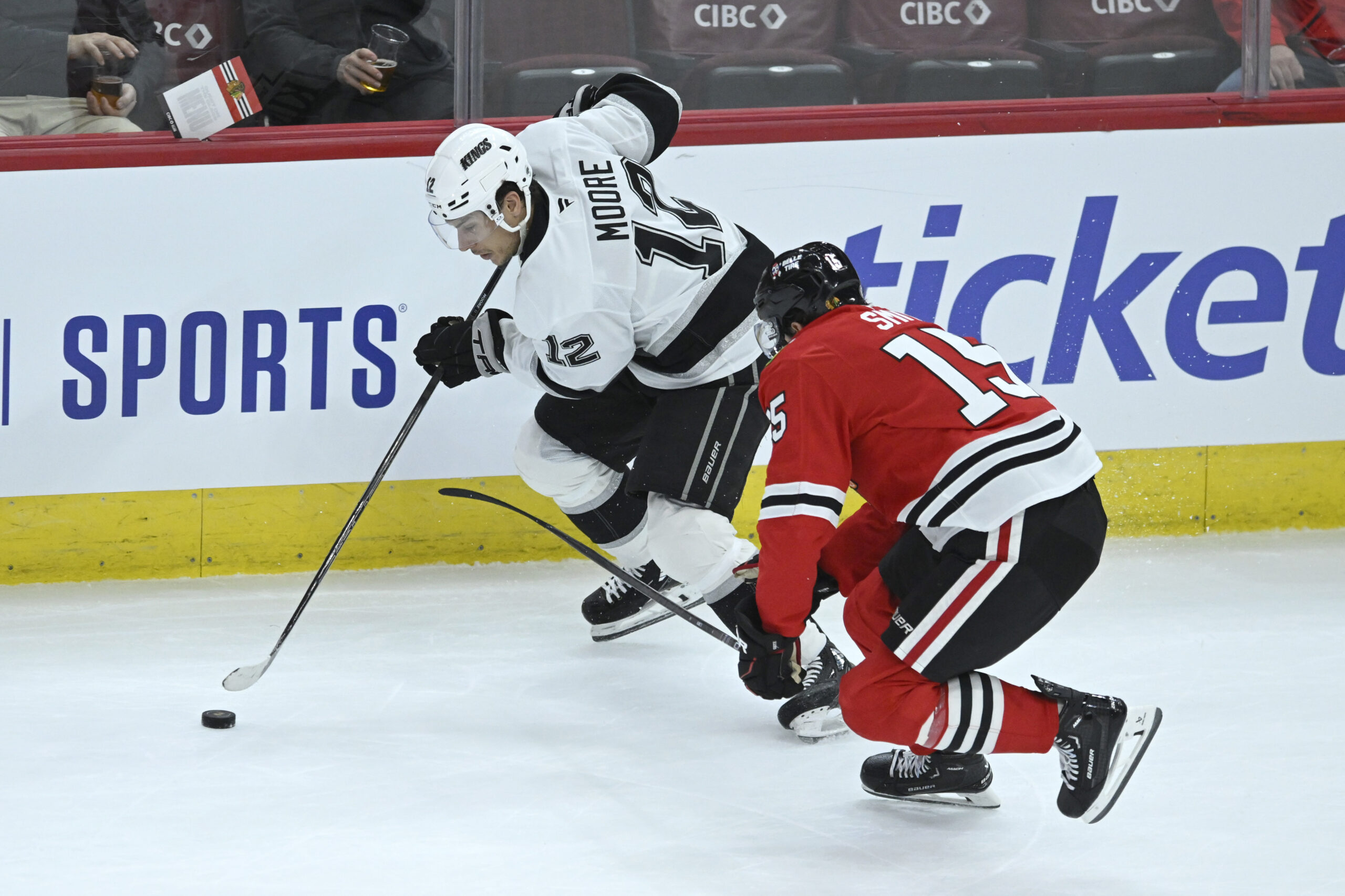 The Kings’ Trevor Moore (12) moves the puck against the...