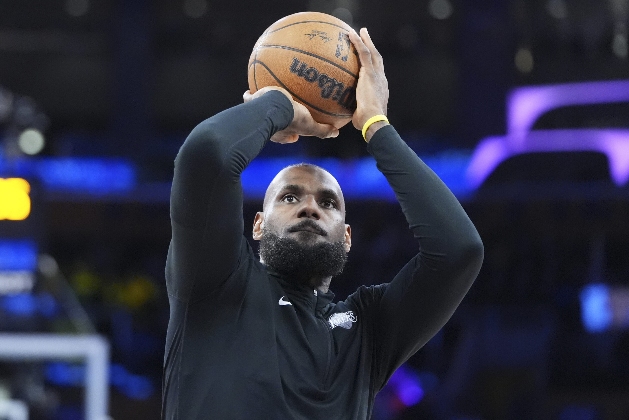 Lakers star LeBron James warms up before an NBA basketball...