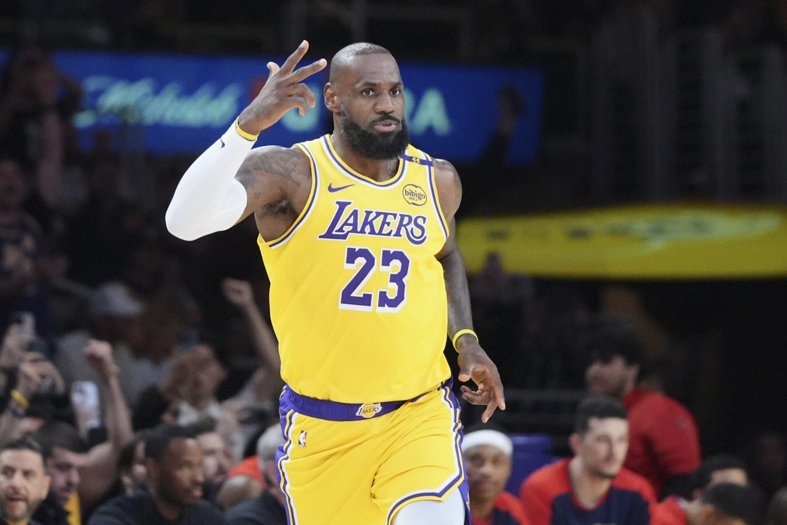 Lakers star LeBron James gestures after making a 3-point shot...