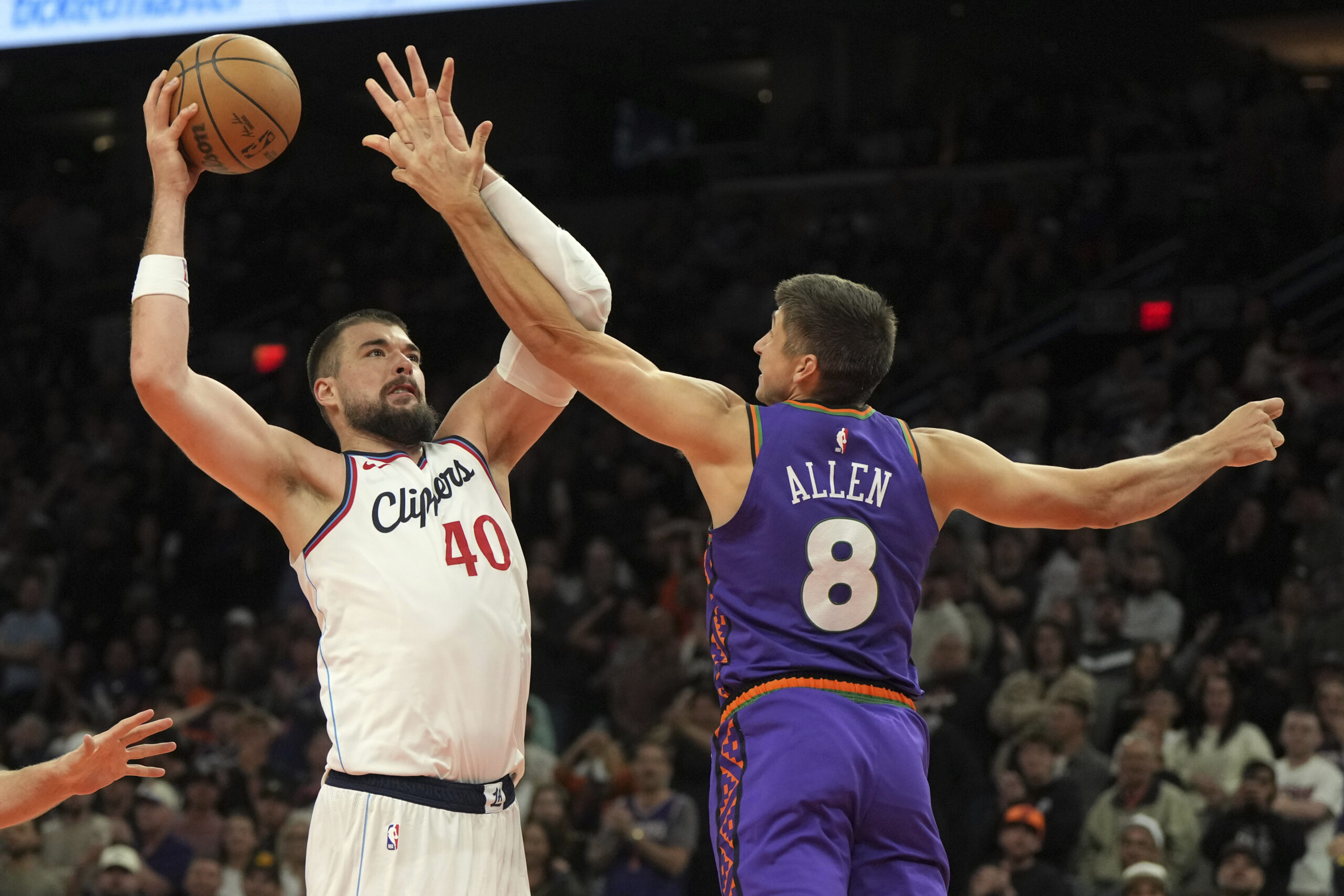 Clippers center Ivica Zubac shoots over Phoenix Suns guard Grayson...