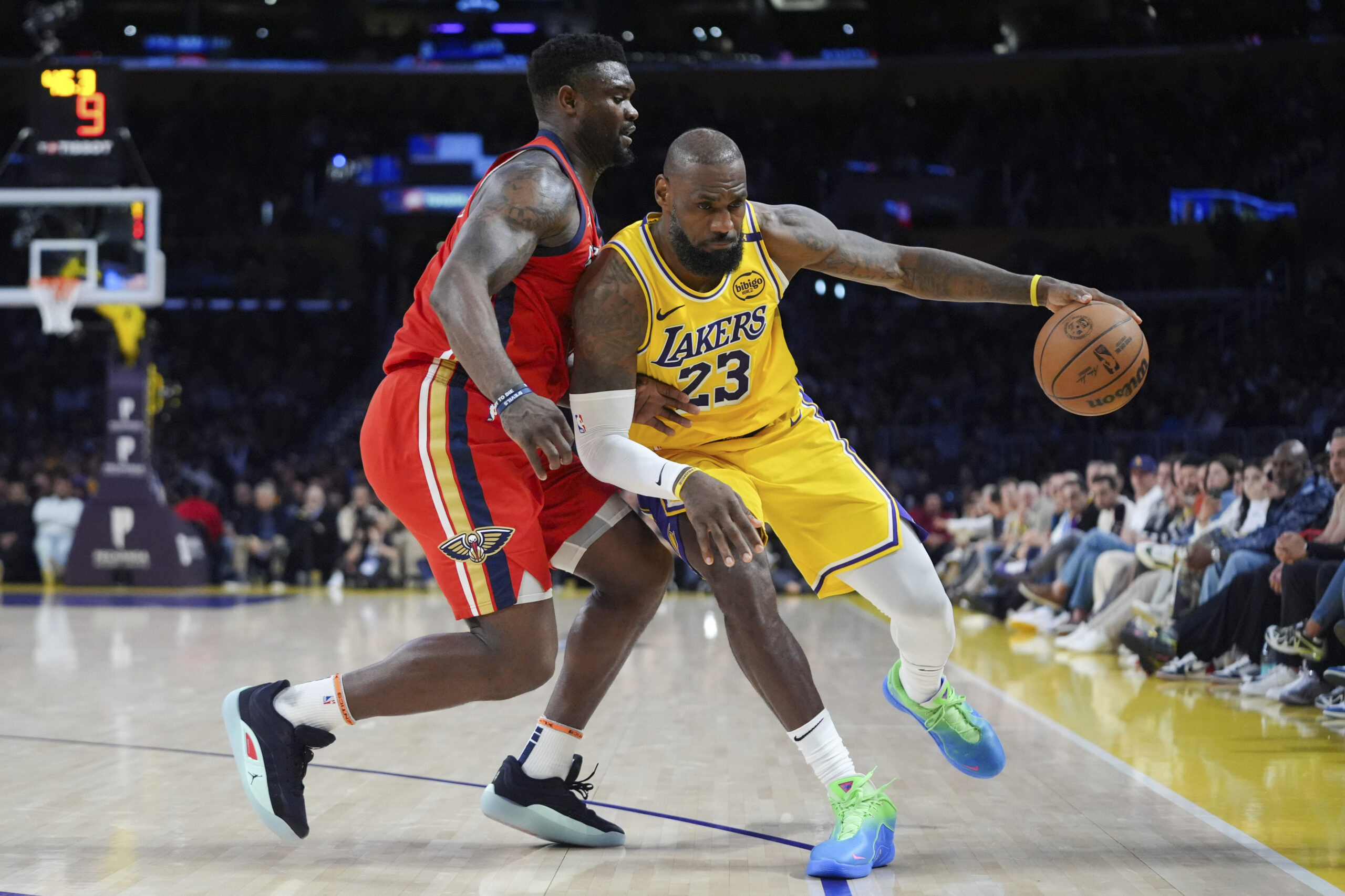 Lakers star LeBron James handles the ball as the New...