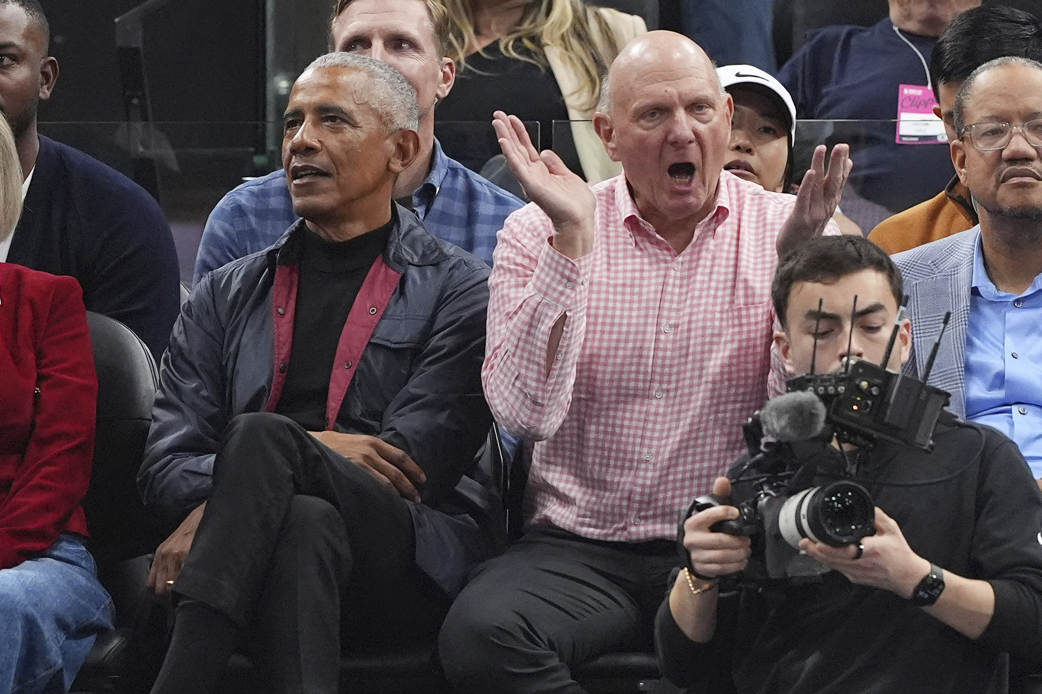 Former President Barack Obama, left, sits with Clippers owner Steve...