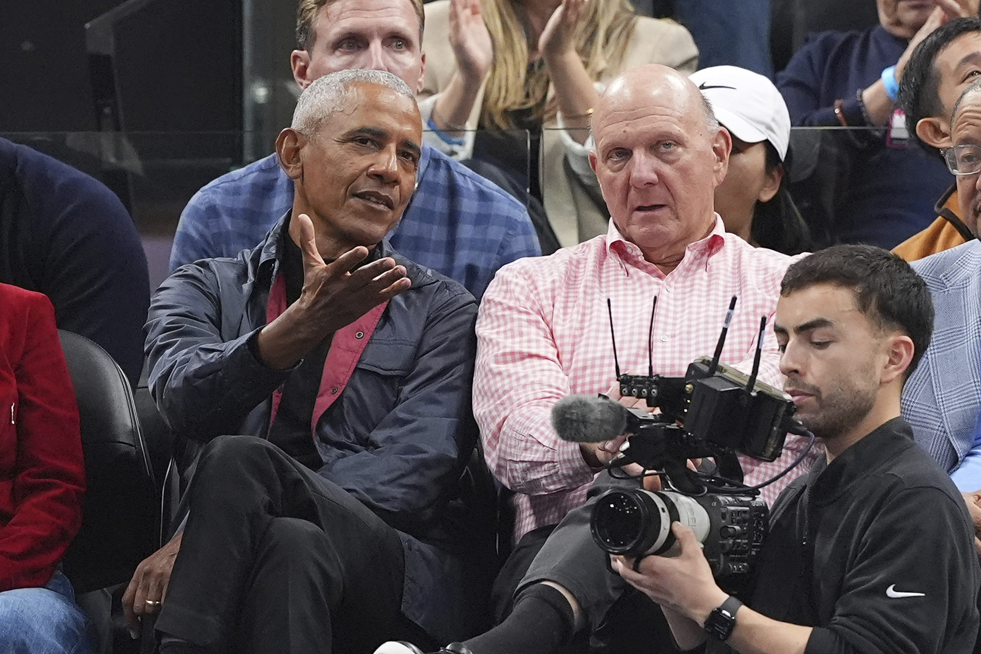 Former President Barack Obama, left, sits with Clippers owner Steve...