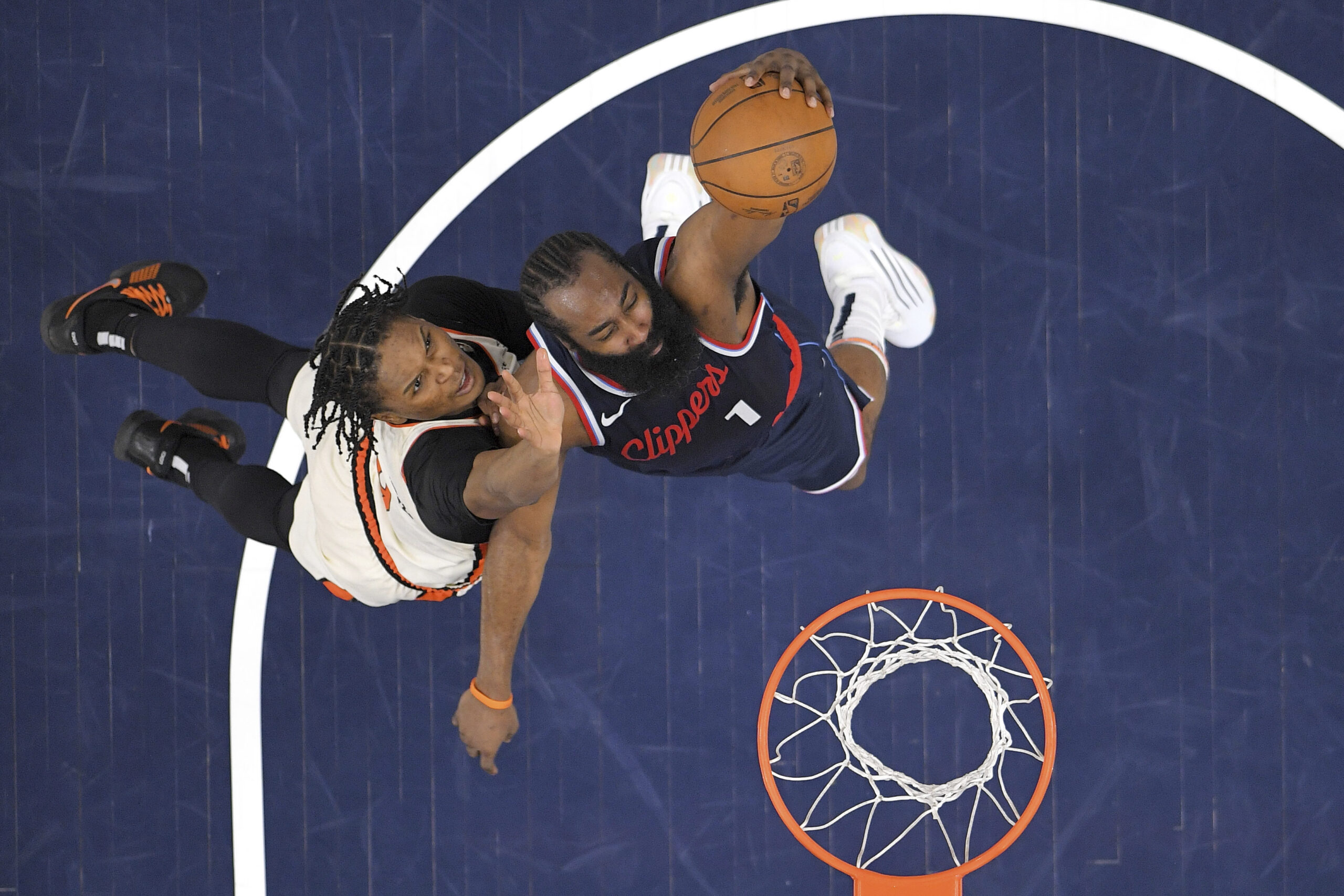 Clippers guard James Harden, right, shoots as Detroit Pistons forward...