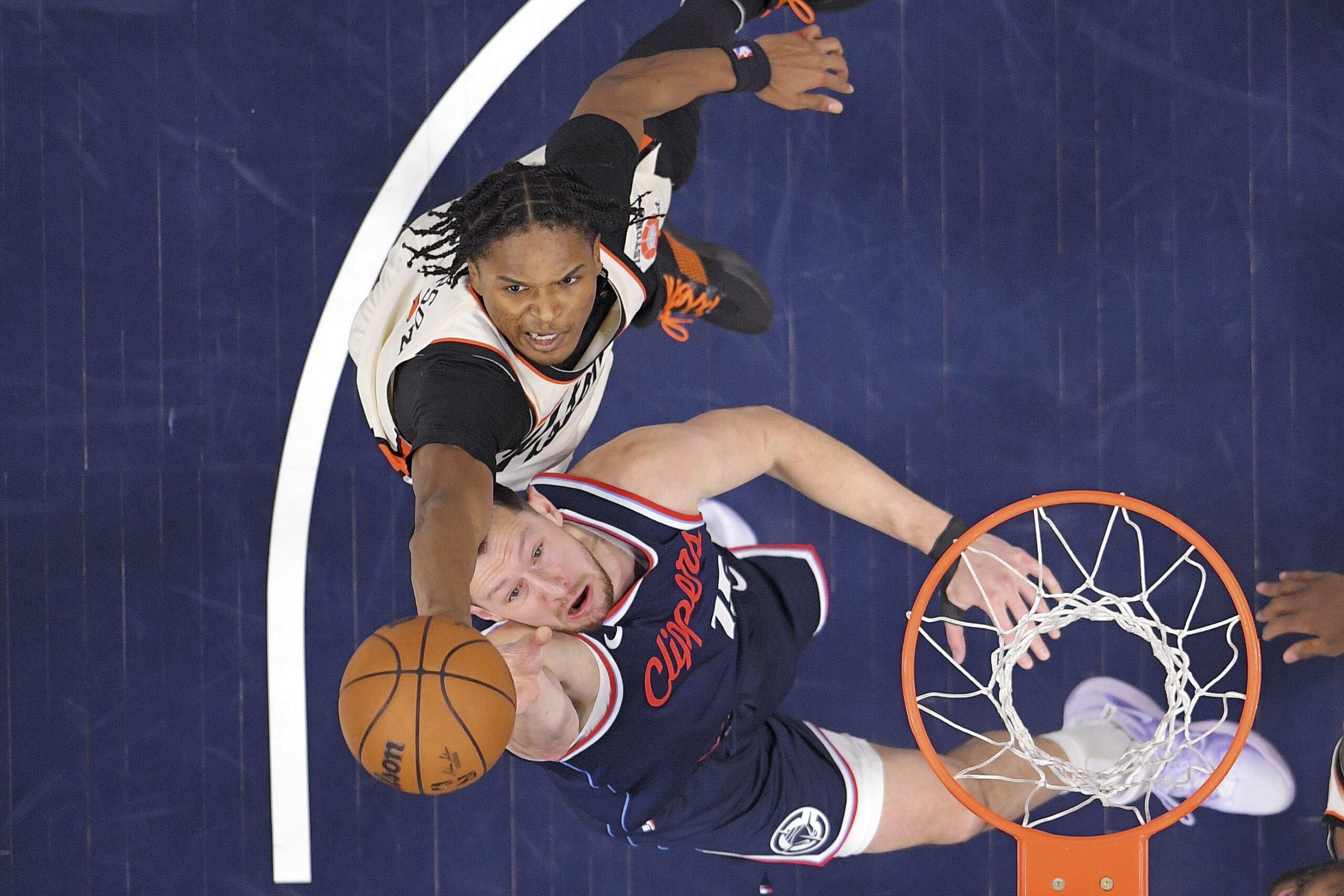 Clippers forward Drew Eubanks, below, and Detroit Pistons forward Ausar...