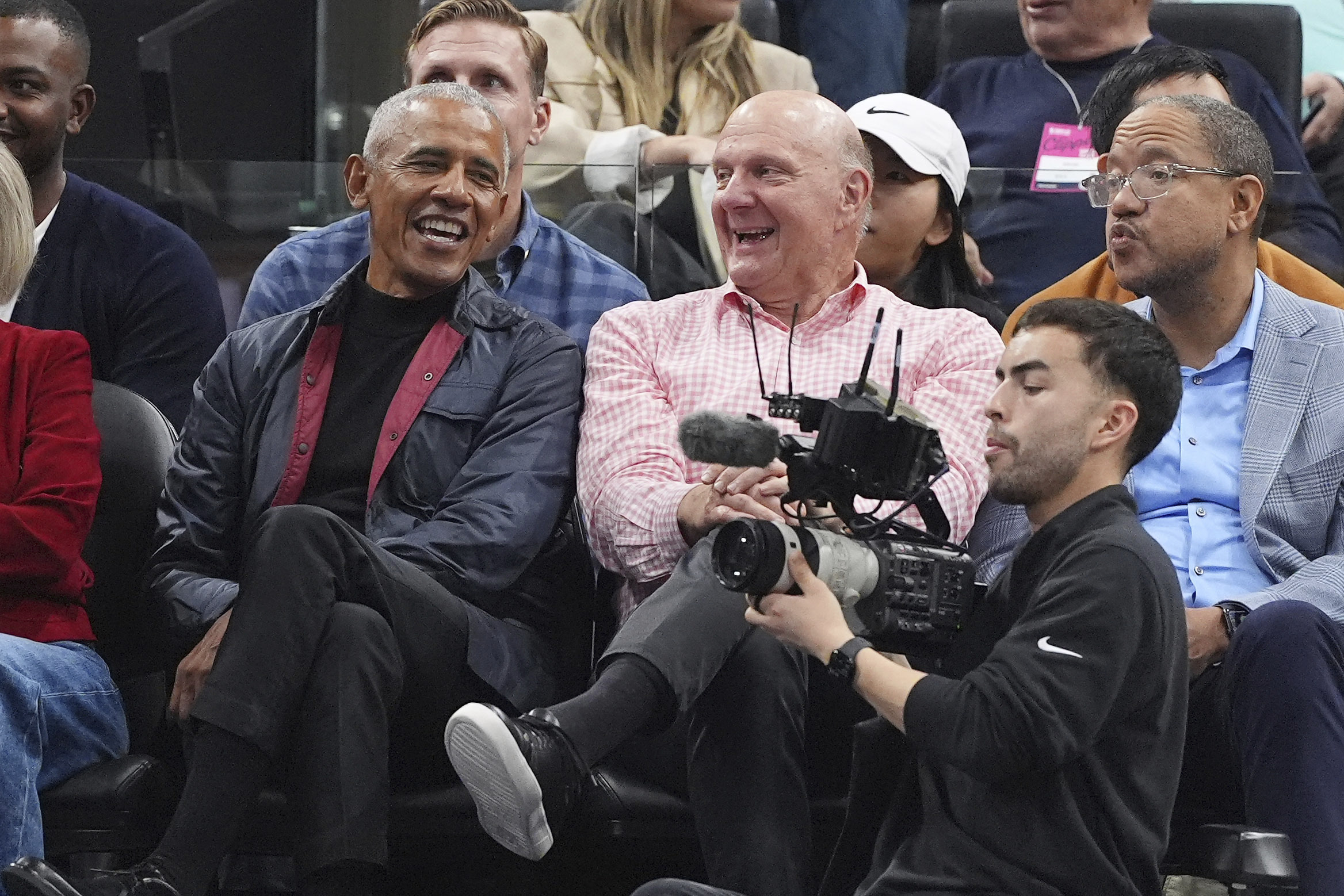 Former President Barack Obama, left, sits with Clippers owner Steve...