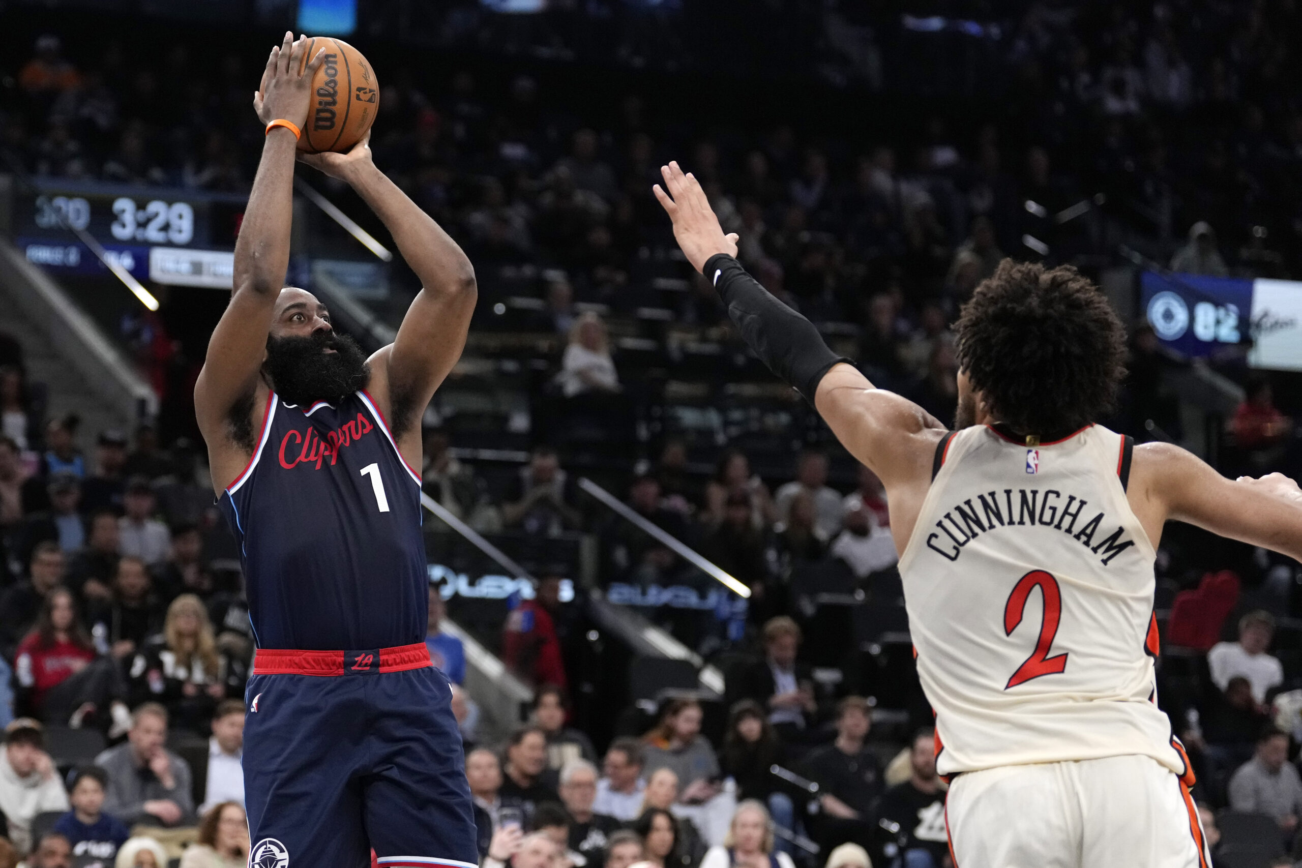 Clippers guard James Harden, left, shoots as Detroit Pistons guard...