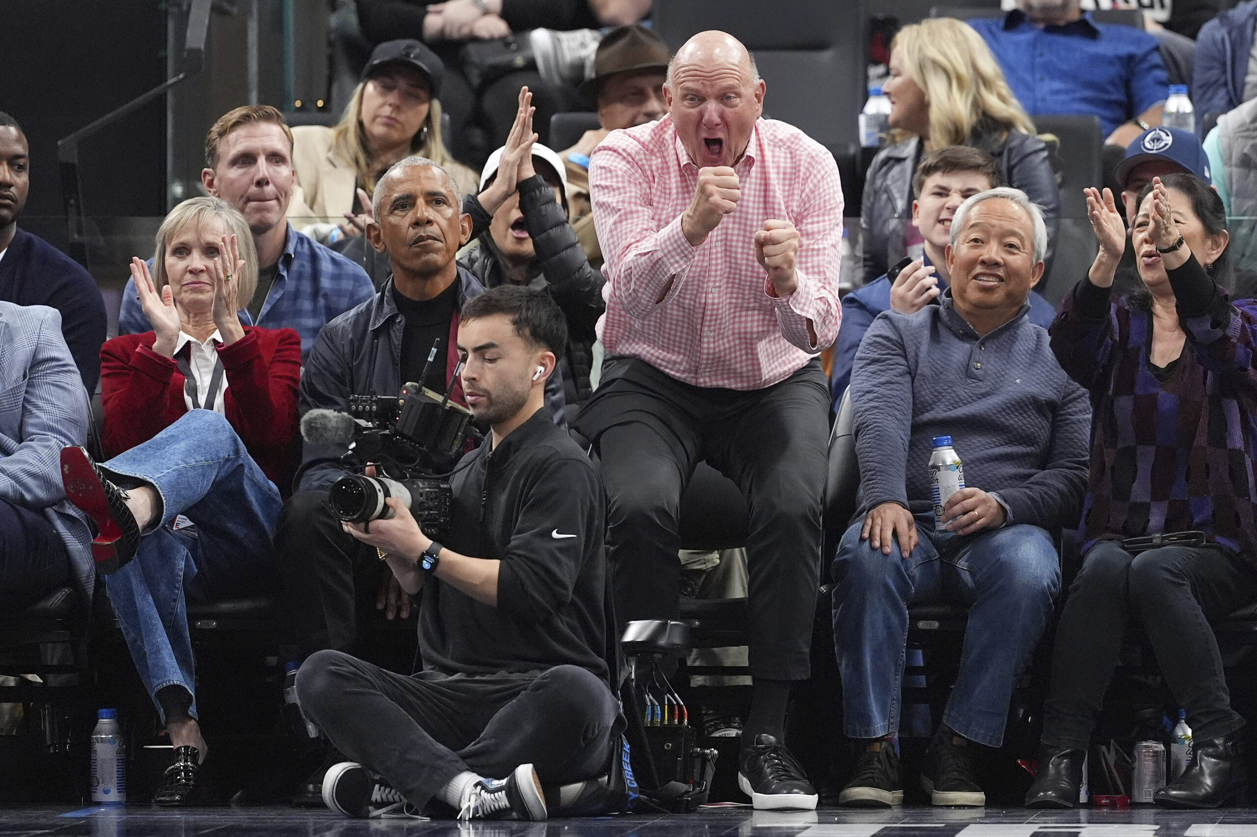 Former President Barack Obama, second from left, sits with Clippers...