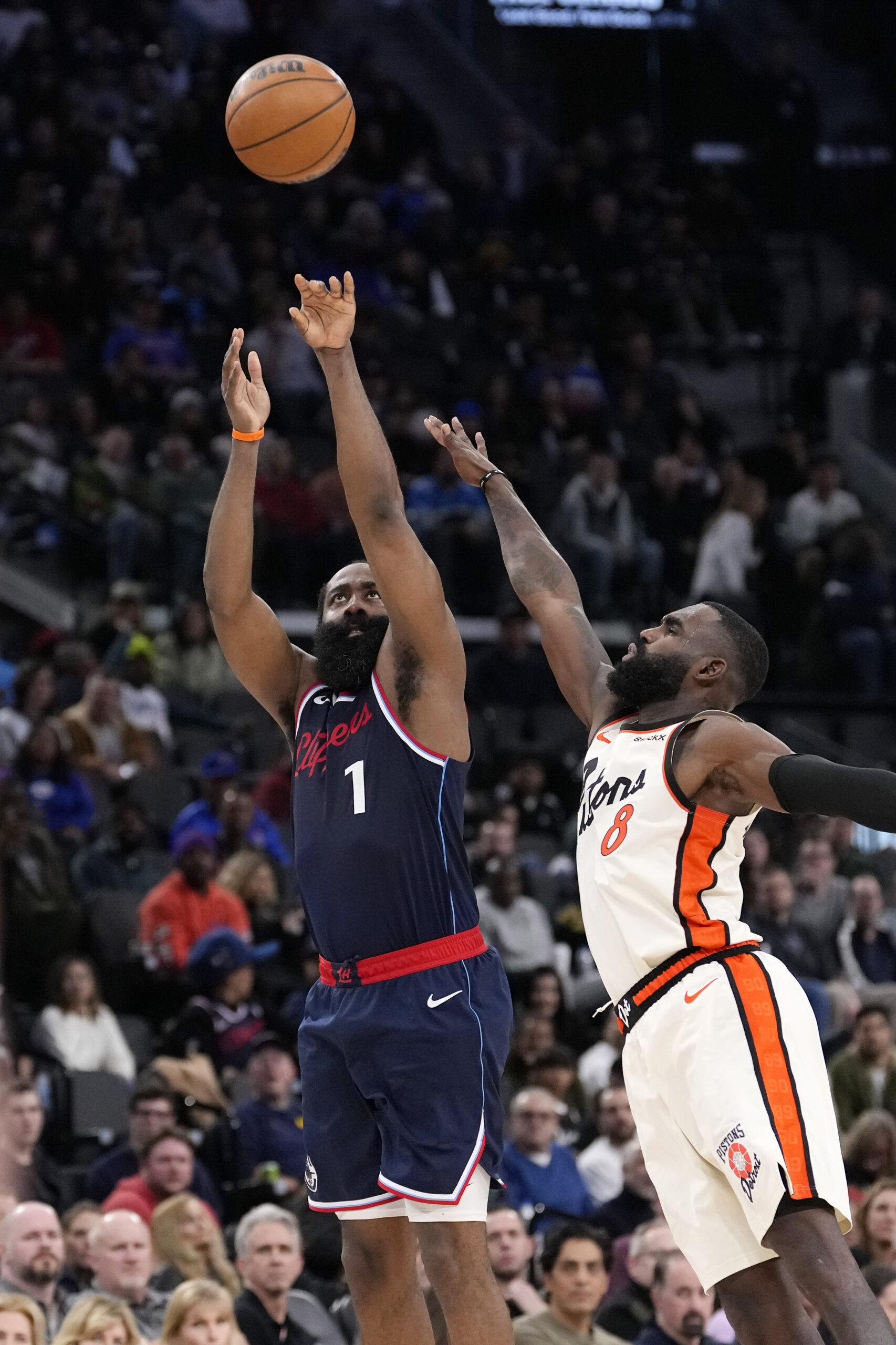 Clippers guard James Harden, left, shoots as Detroit Pistons forward...