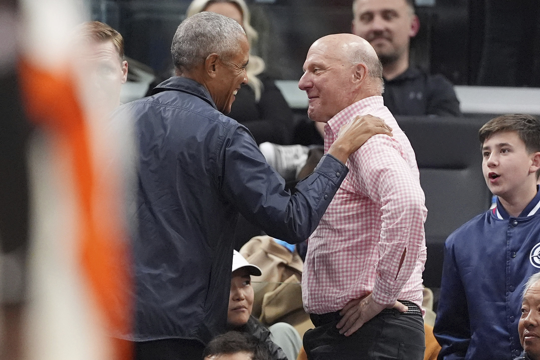 Former President Barack Obama, left, says goodbye to Clippers owner...