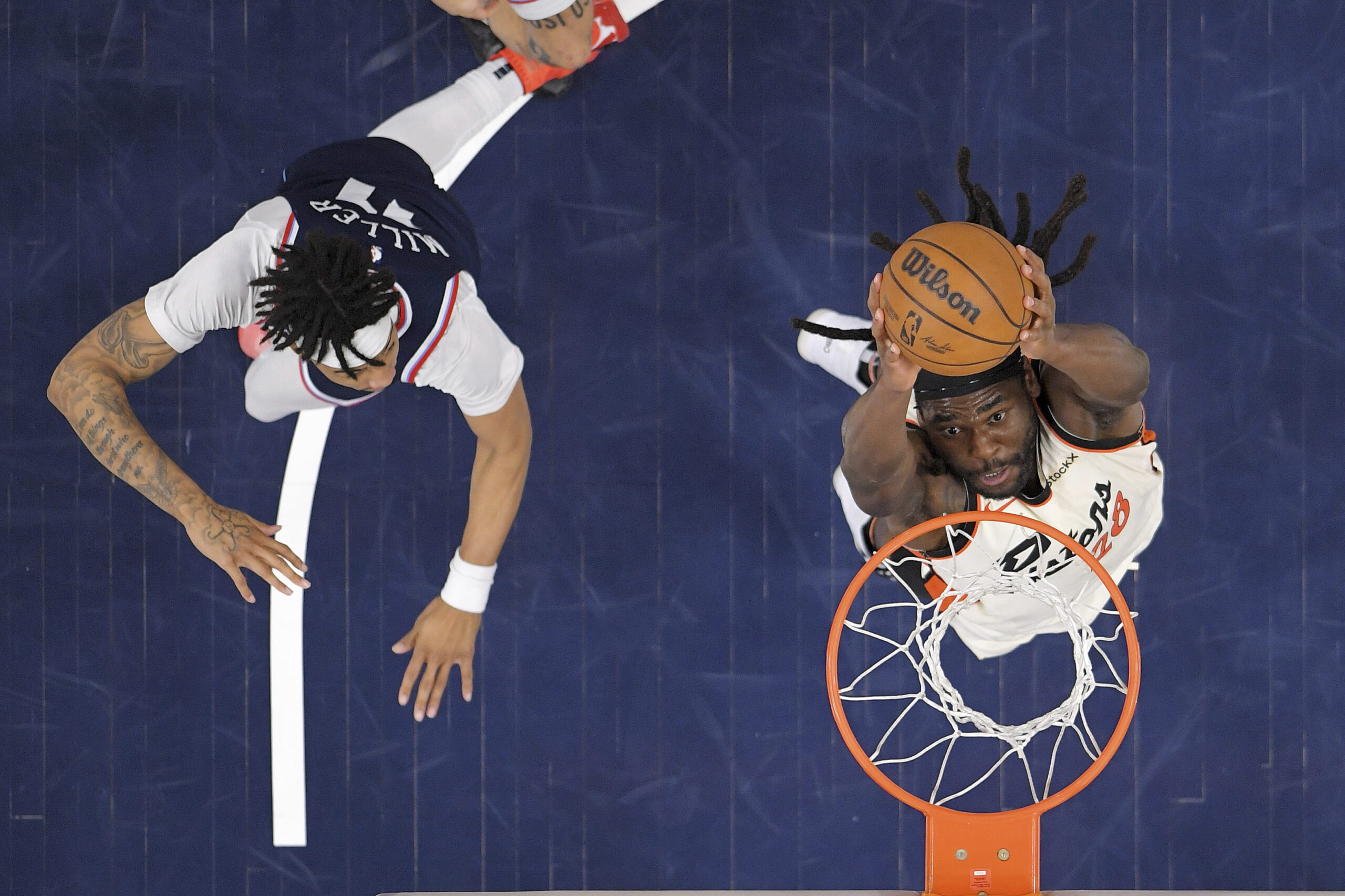 Detroit Pistons center Isaiah Stewart, right, dunks as Clippers guard...