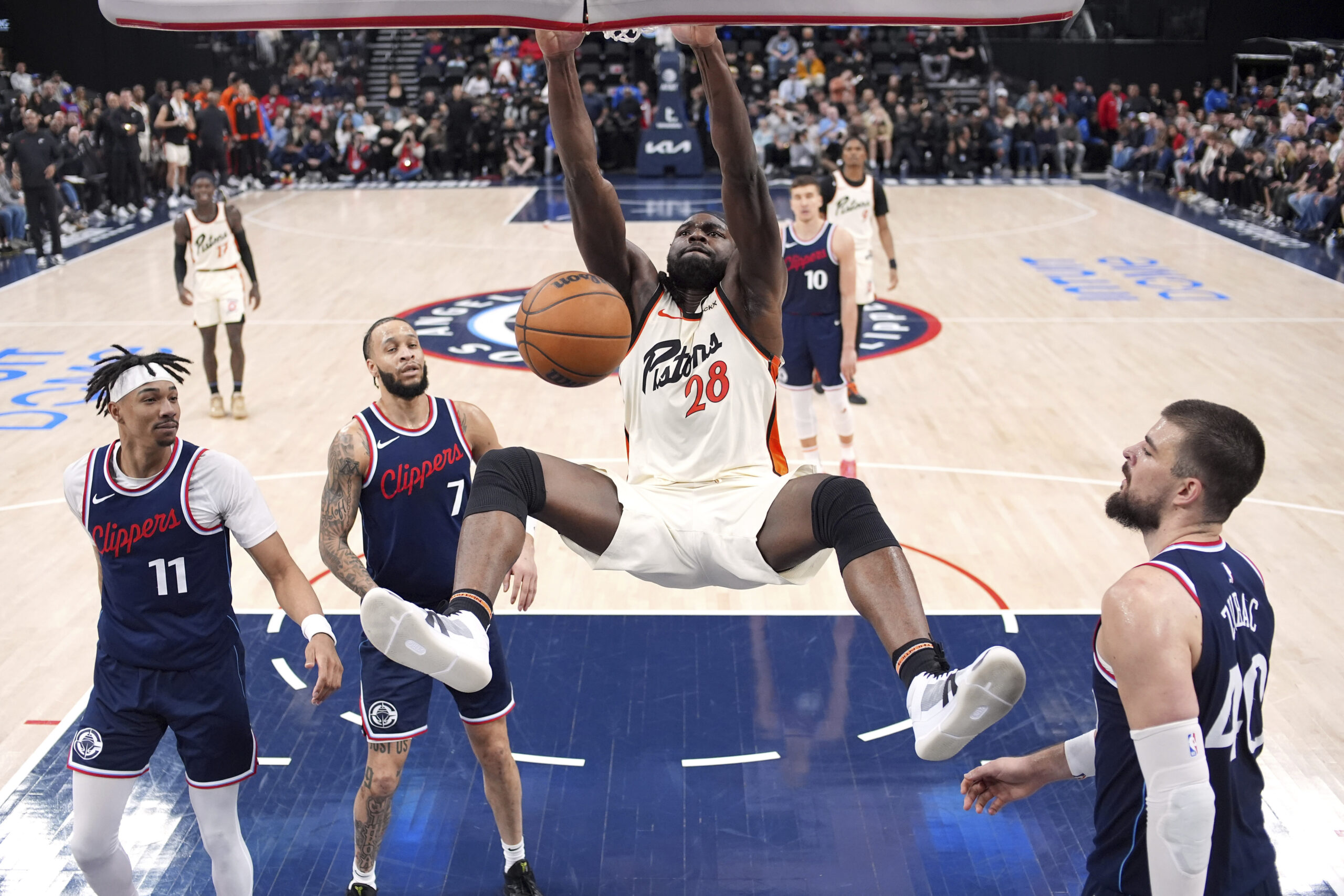 Detroit Pistons center Isaiah Stewart, center, dunks as Clippers guard...