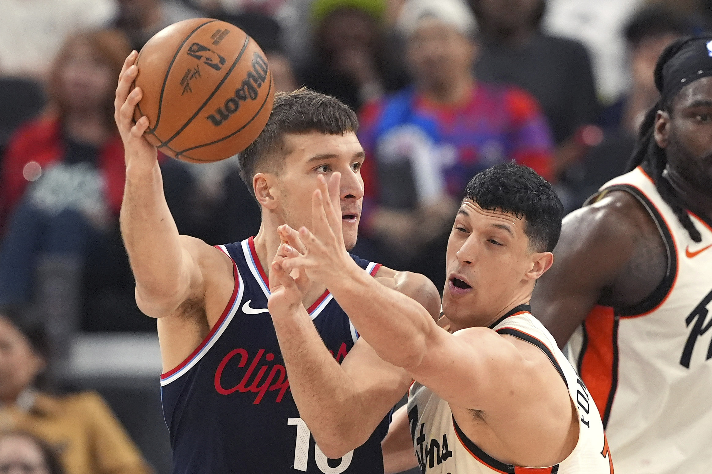 Clippers guard Bogdan Bogdanovic, left, passes while under pressure from...