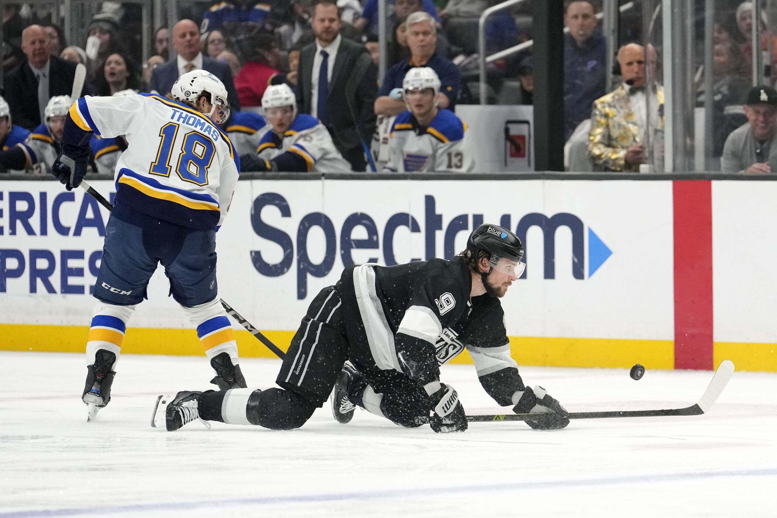 Kings right wing Adrian Kempe, right, falls as St. Louis...