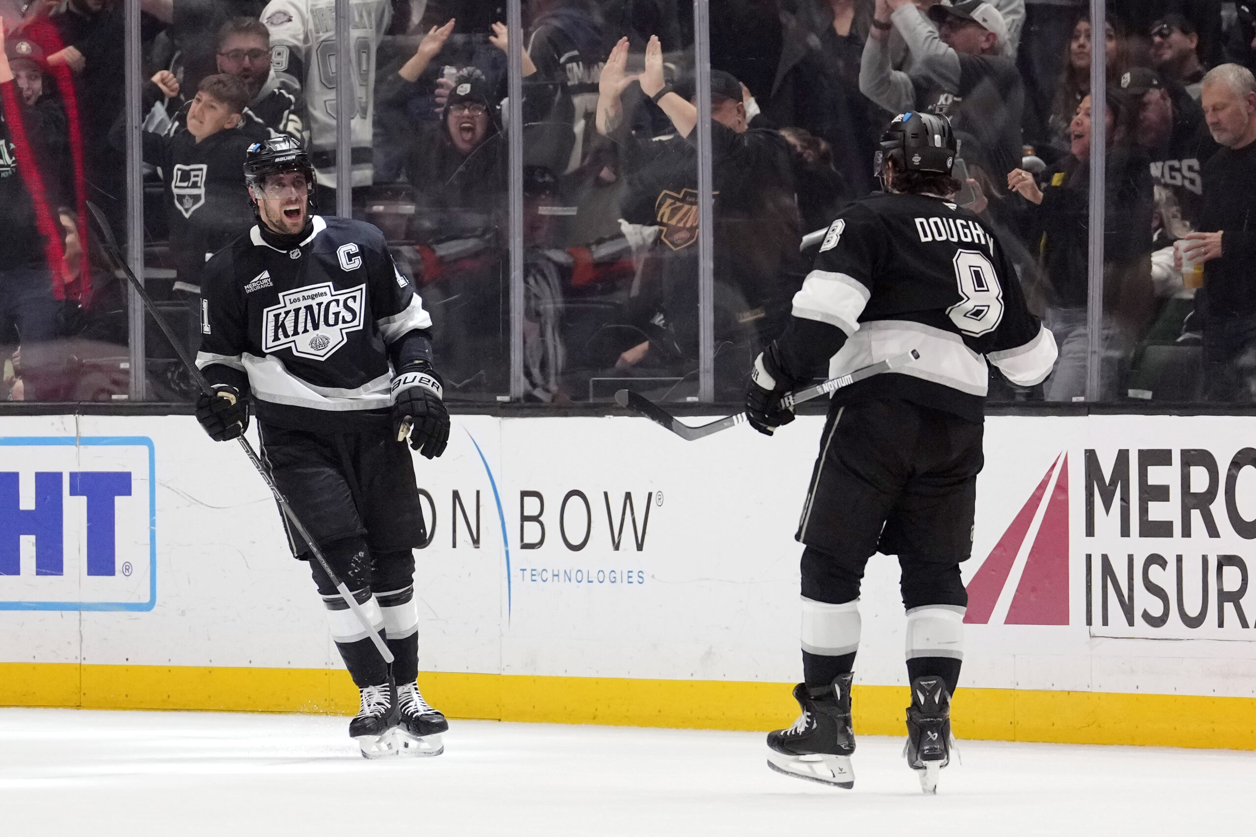 Kings center Anze Kopitar celebrates his goal with defenseman Drew...