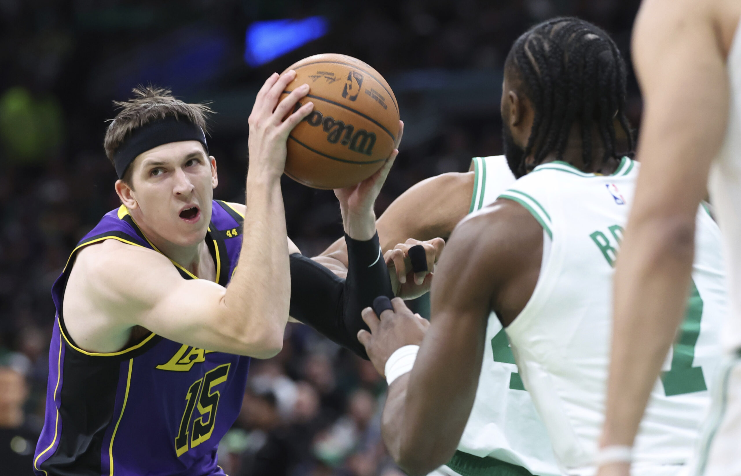 Lakers guard Austin Reaves (15) defends the ball from the...