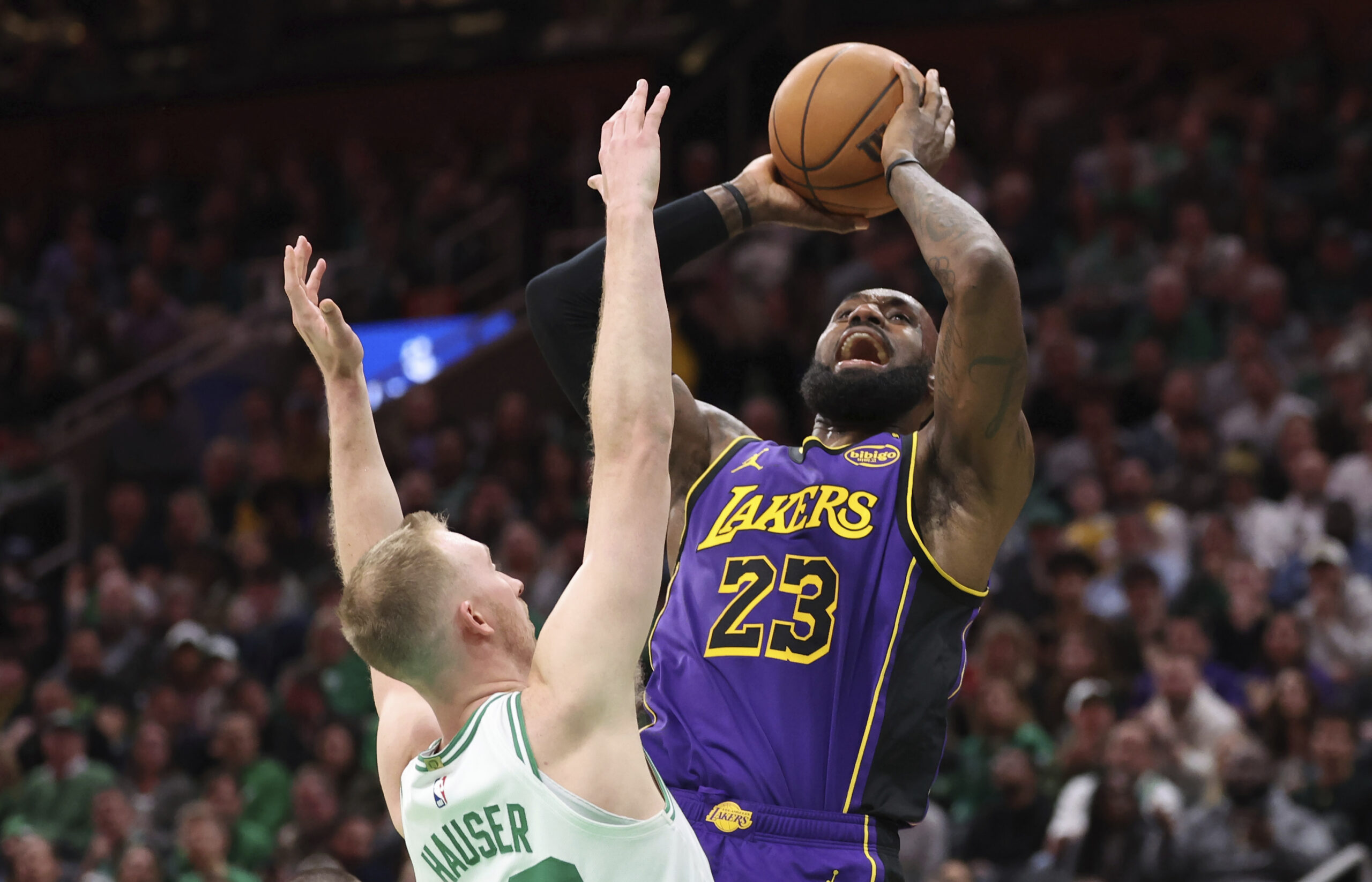 Lakers forward LeBron James, right, shoots over Boston Celtics forward...