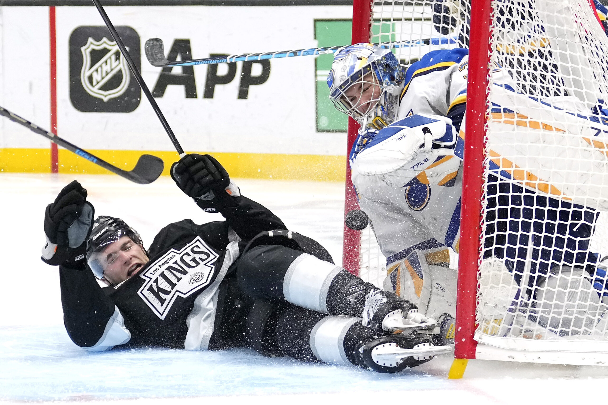 Kings right wing Alex Laferriere, left, runs into St. Louis...