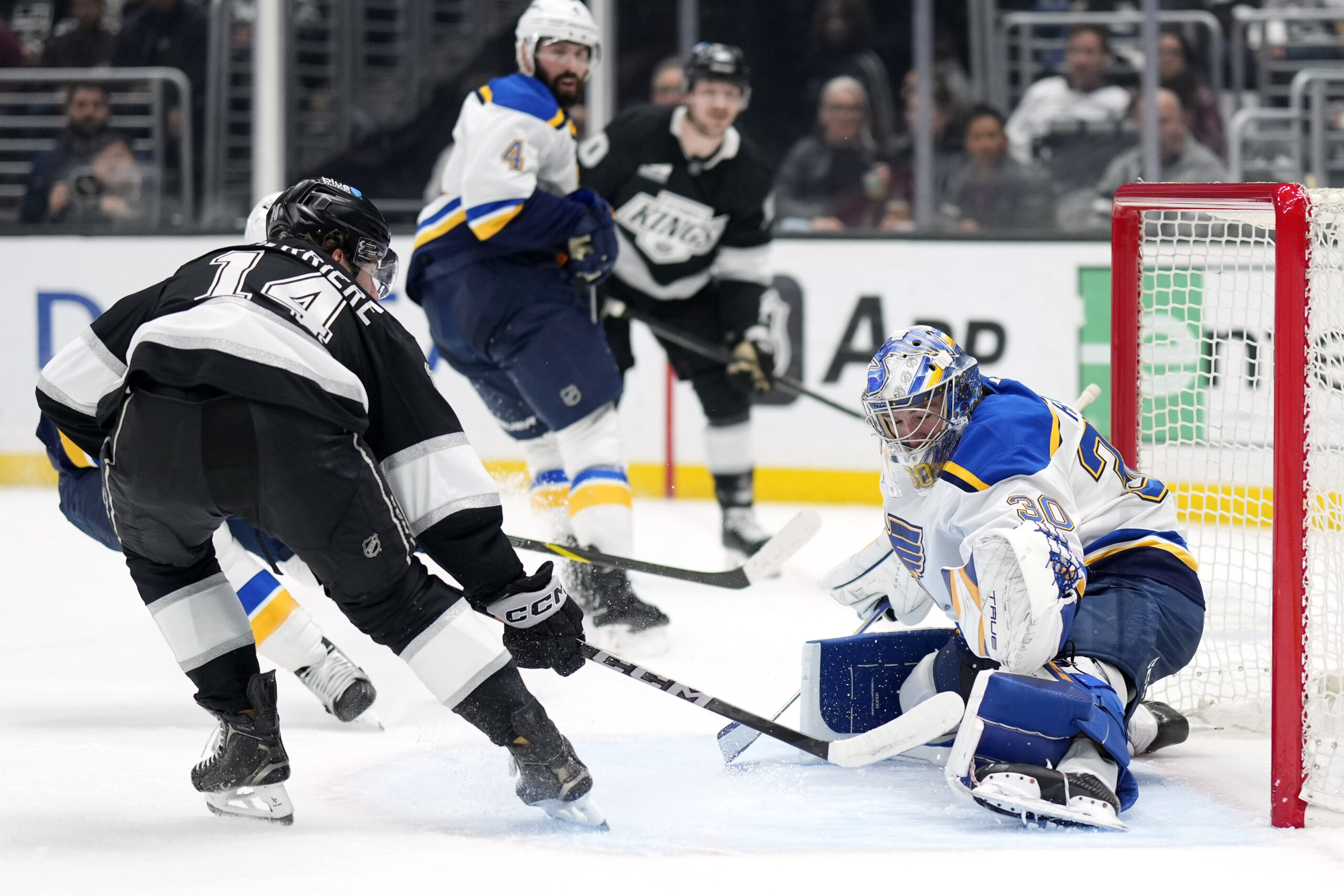 Kings right wing Alex Laferriere, left, tries to score on...