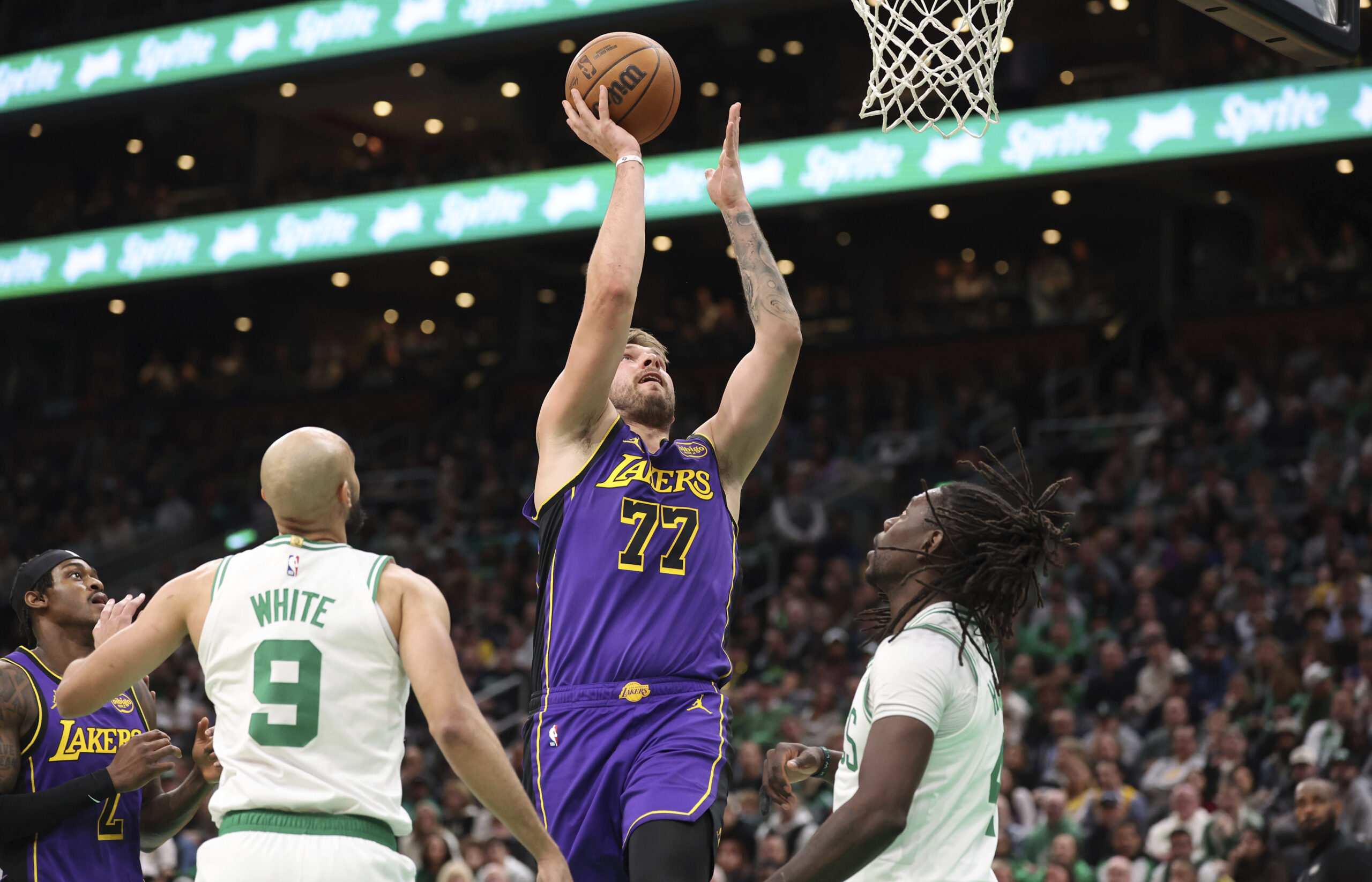 Lakers guard Luka Doncic (77) scores during the first half...