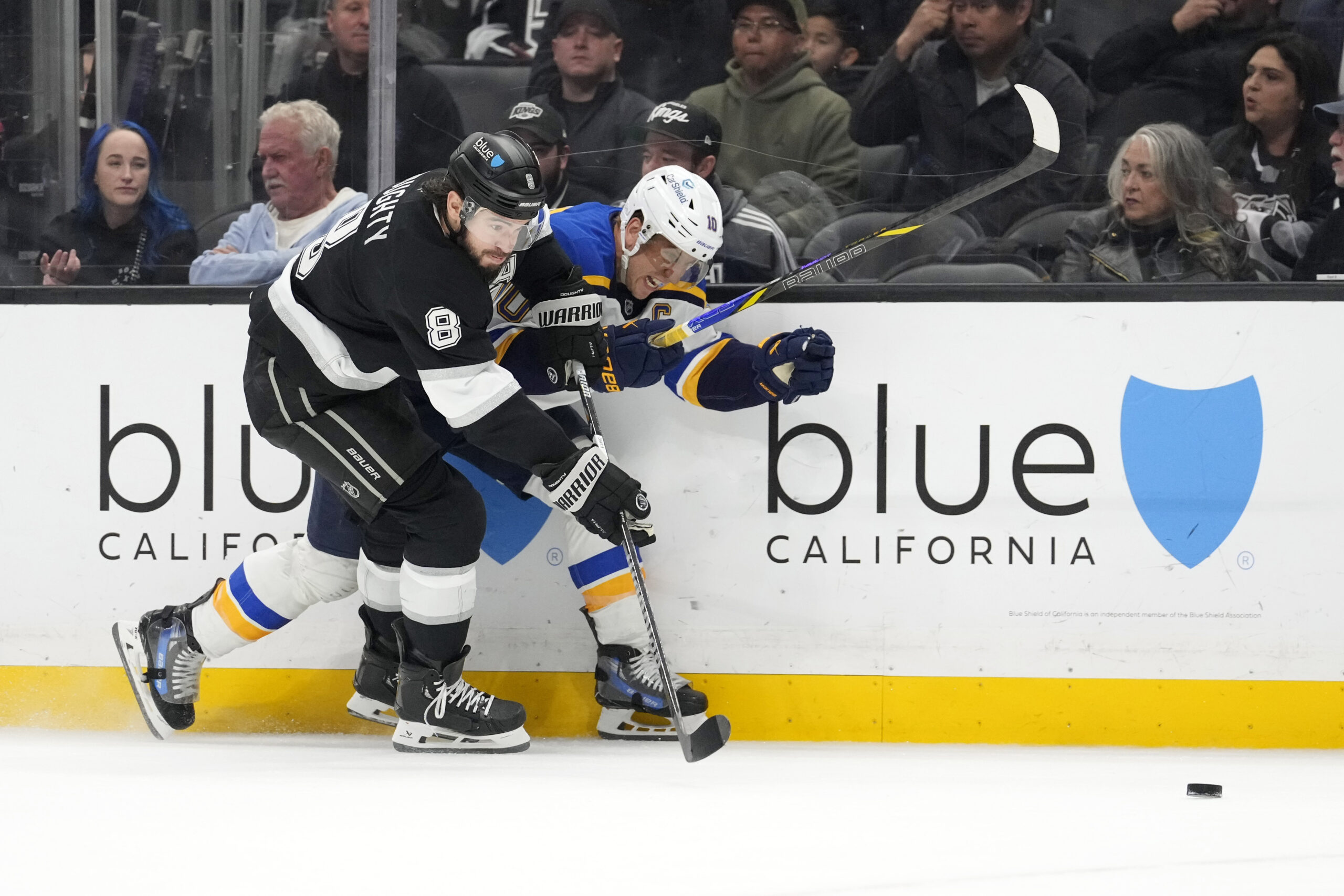 Kings defenseman Drew Doughty, left, and St. Louis Blues center...