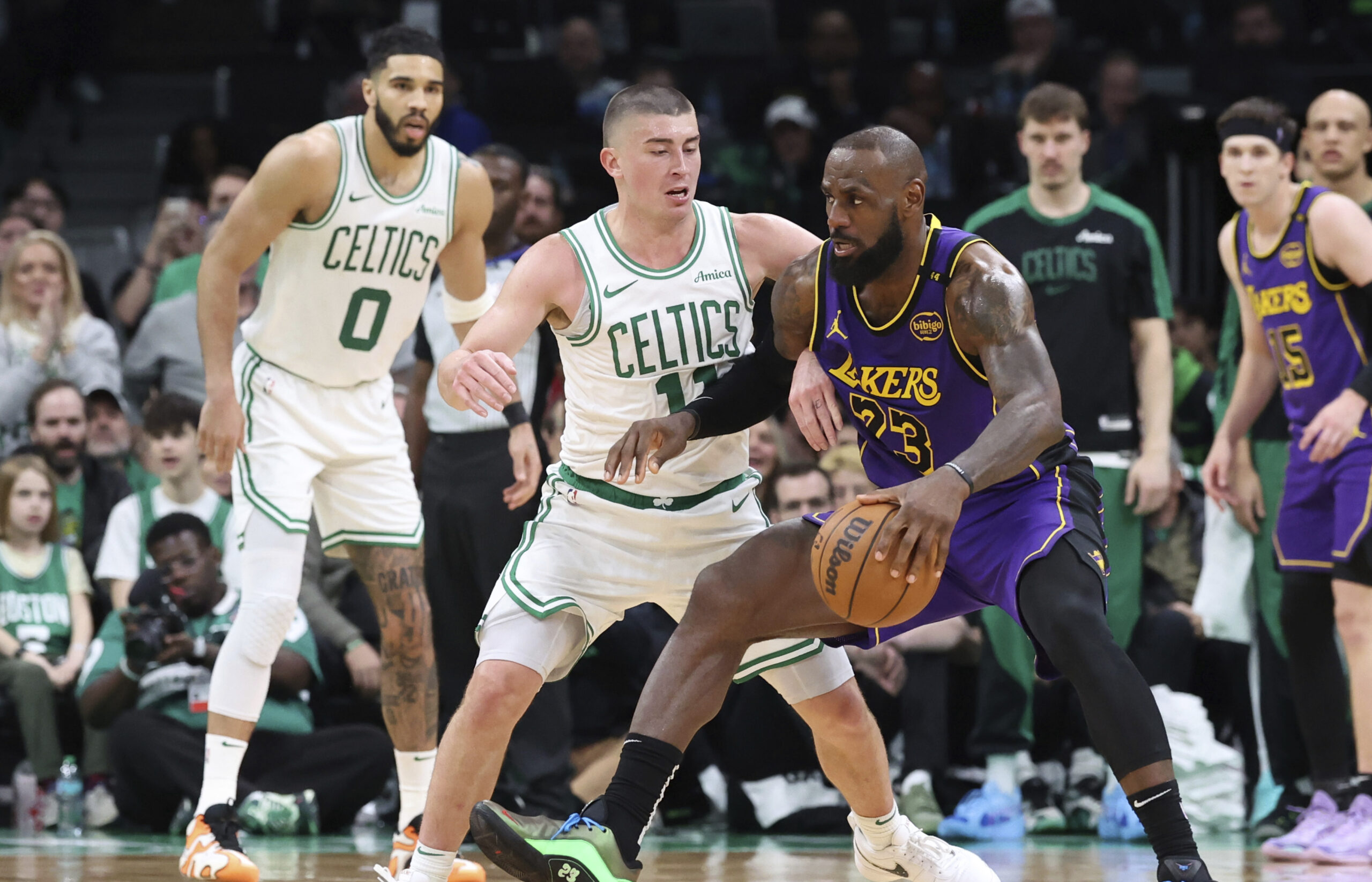 Lakers forward LeBron James (23) defends the ball from Boston...