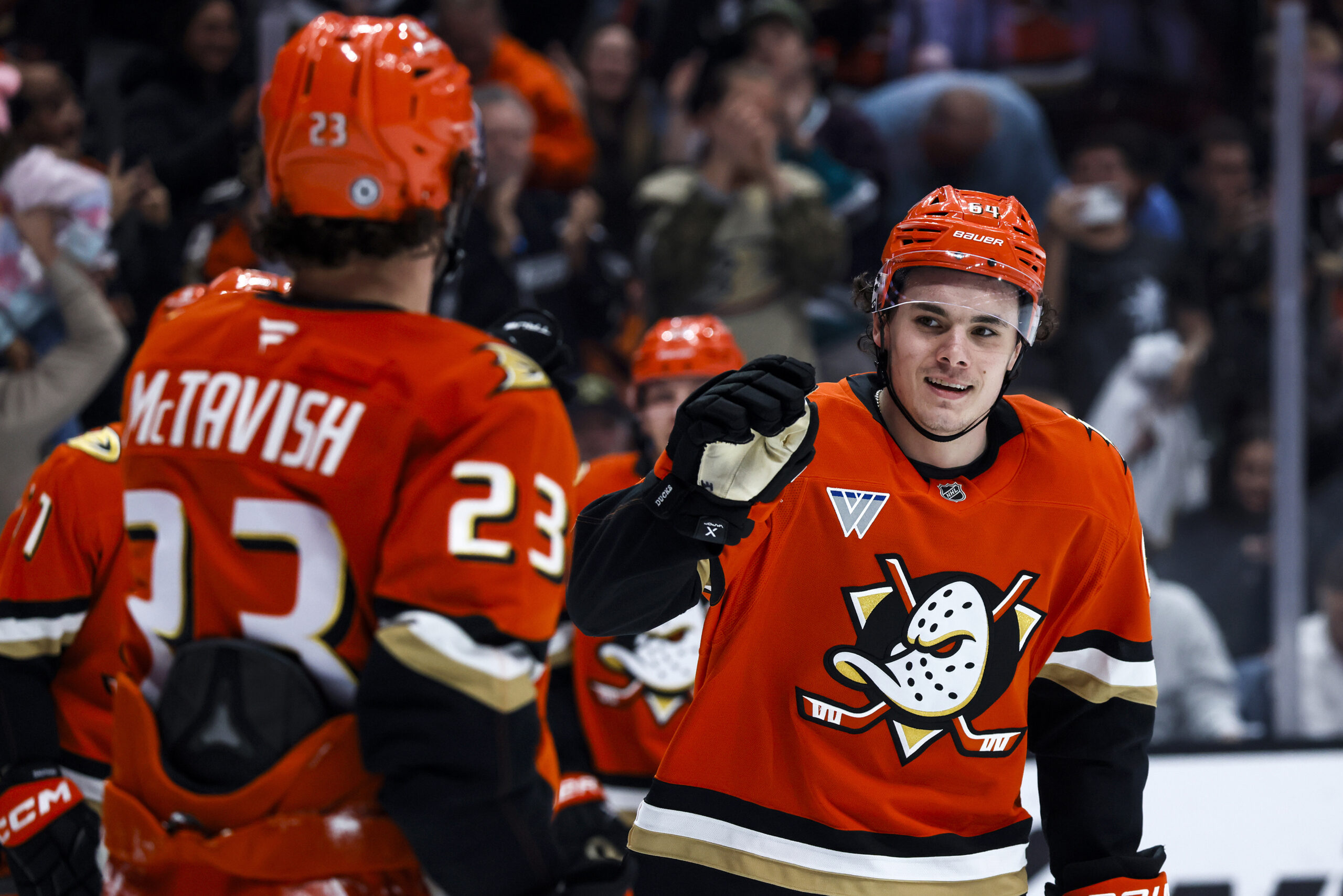 Ducks winger Sam Colangelo, right, celebrates with center Mason McTavish...