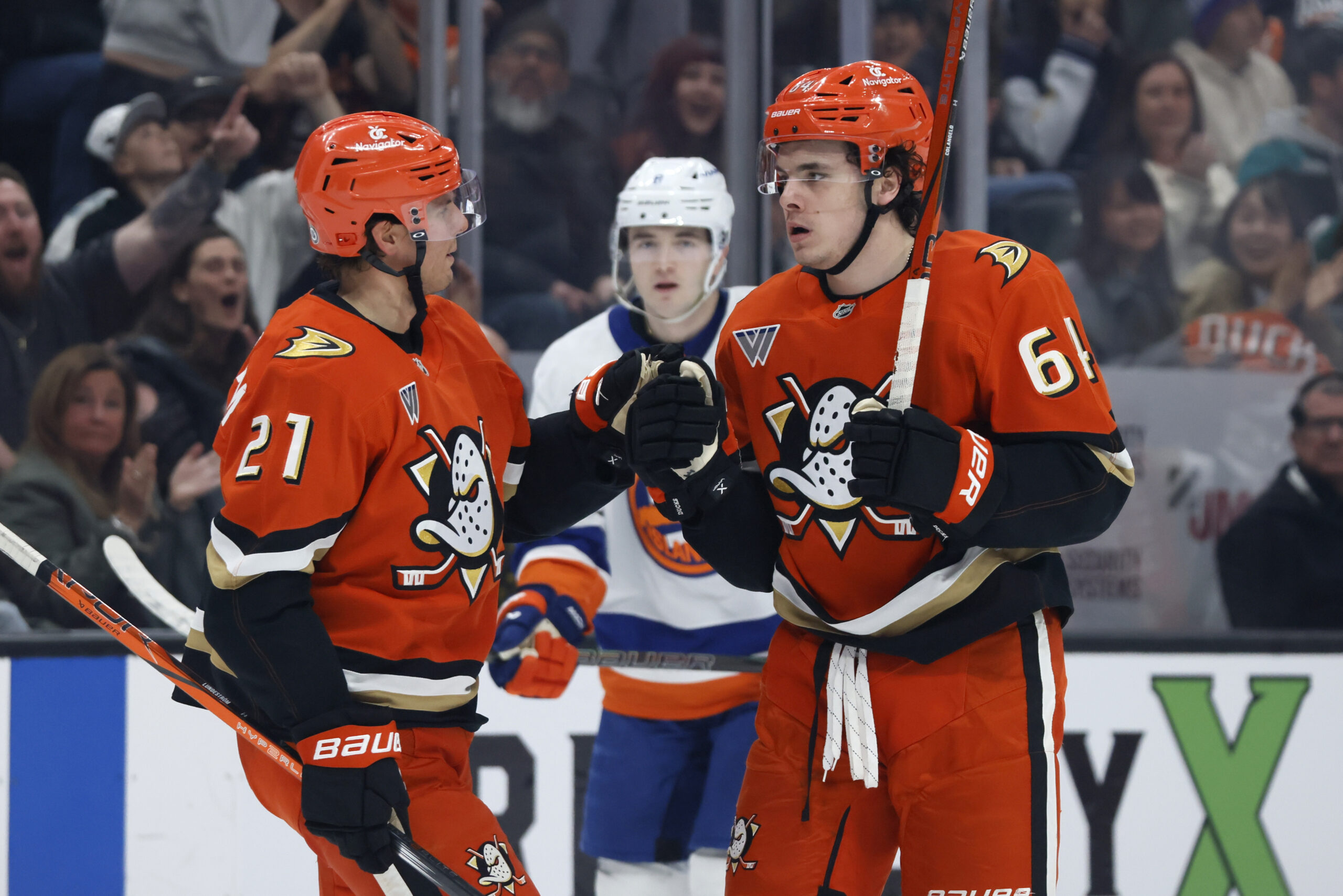 Ducks winger Sam Colangelo, right, celebrates with center Isac Lundestrom...