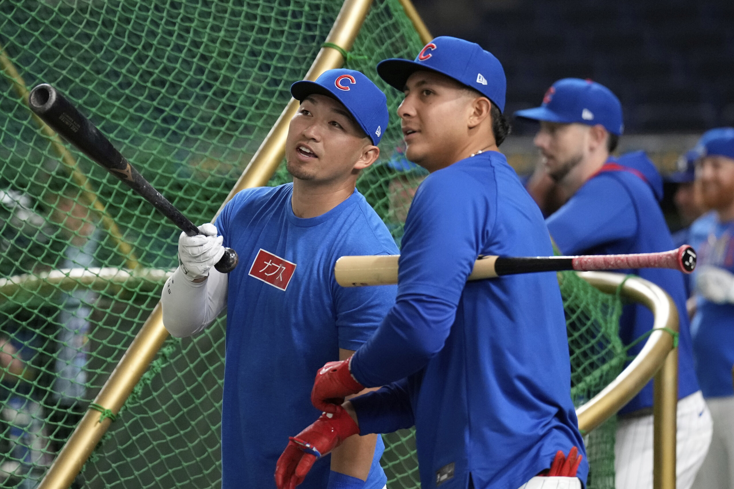 The Chicago Cubs’ Seiya Suzuki, left, talks with teammate Miguel...