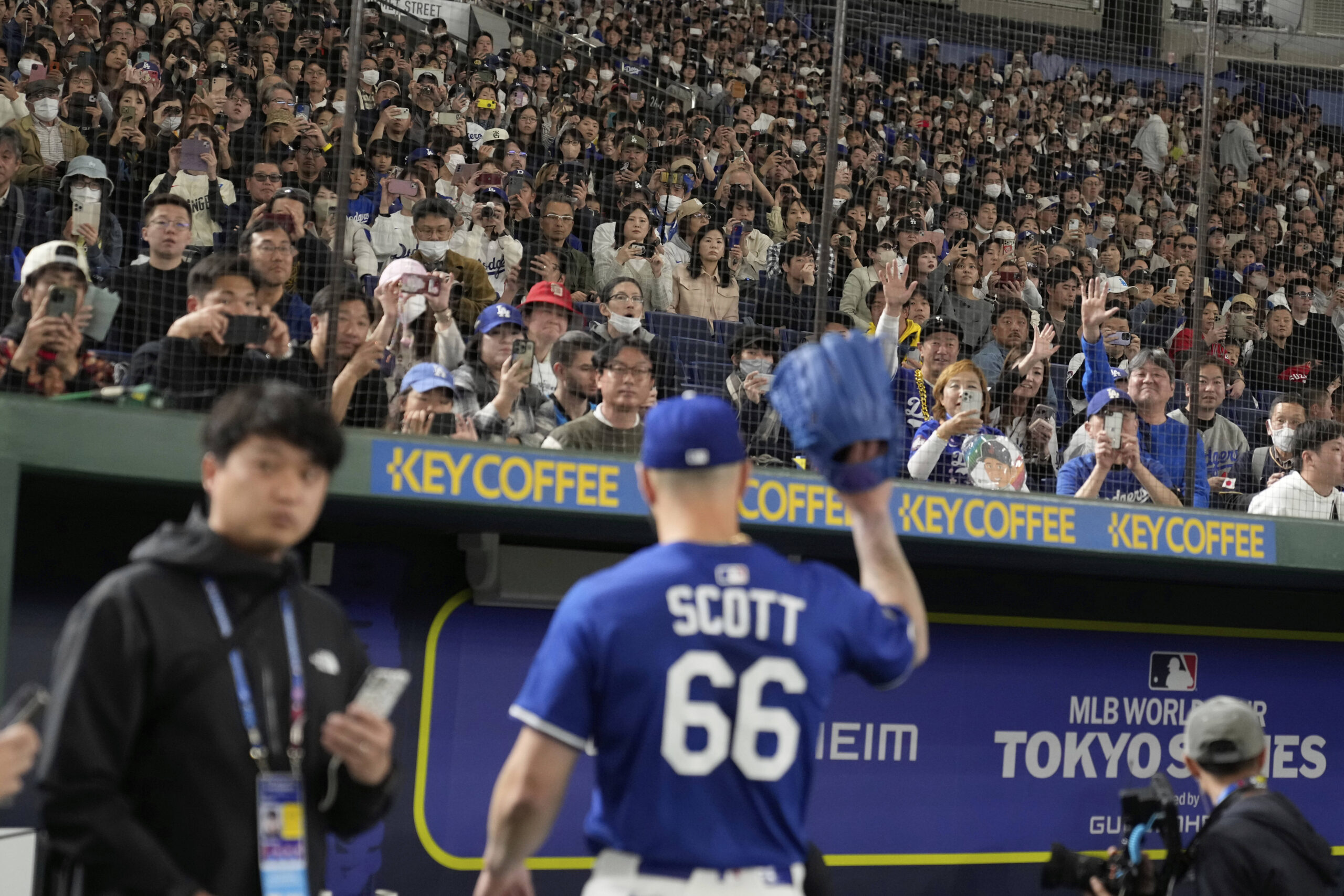 Dodgers relief pitcher Tanner Scott waves during a practice session...