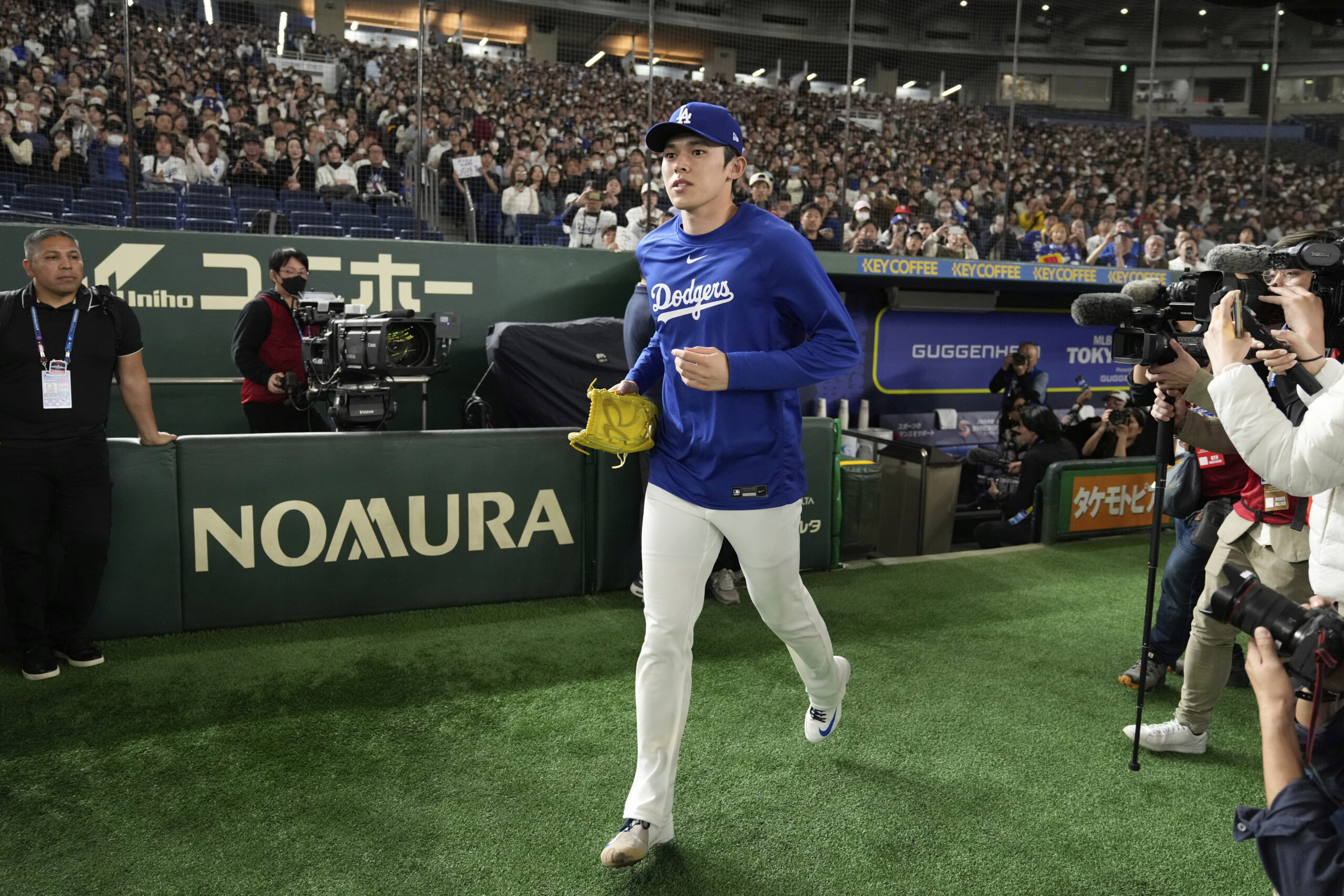 Dodgers pitcher Roki Sasaki takes the field to participate in...