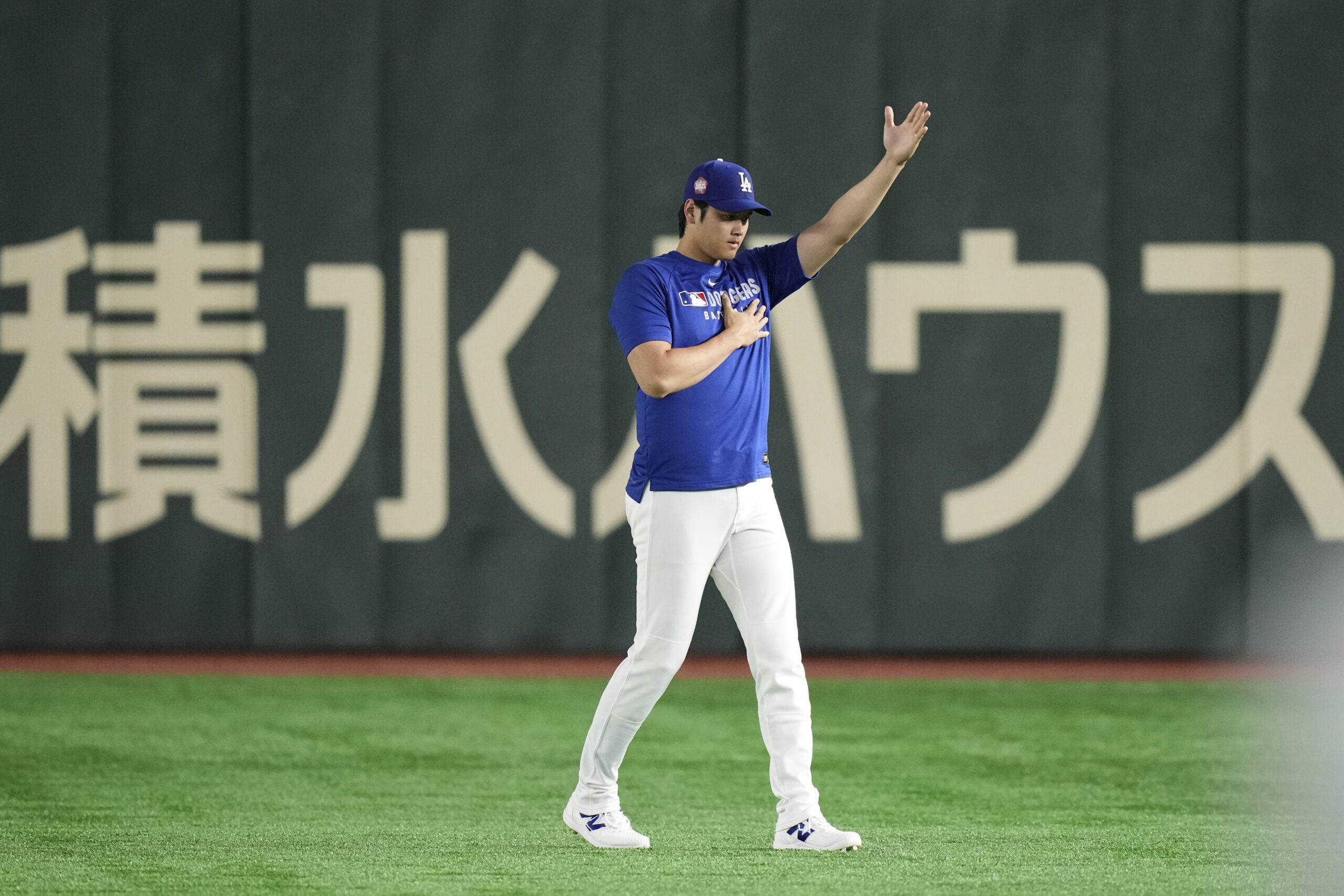 Dodgers star Shohei Ohtani stretches at the beginning of a...