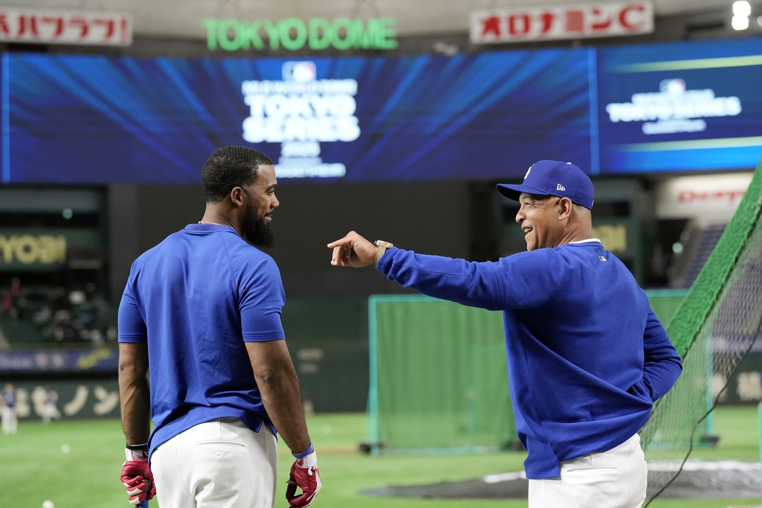 Dodgers outfielder Teoscar Hernández, left, and Manager Dave Roberts, right,...