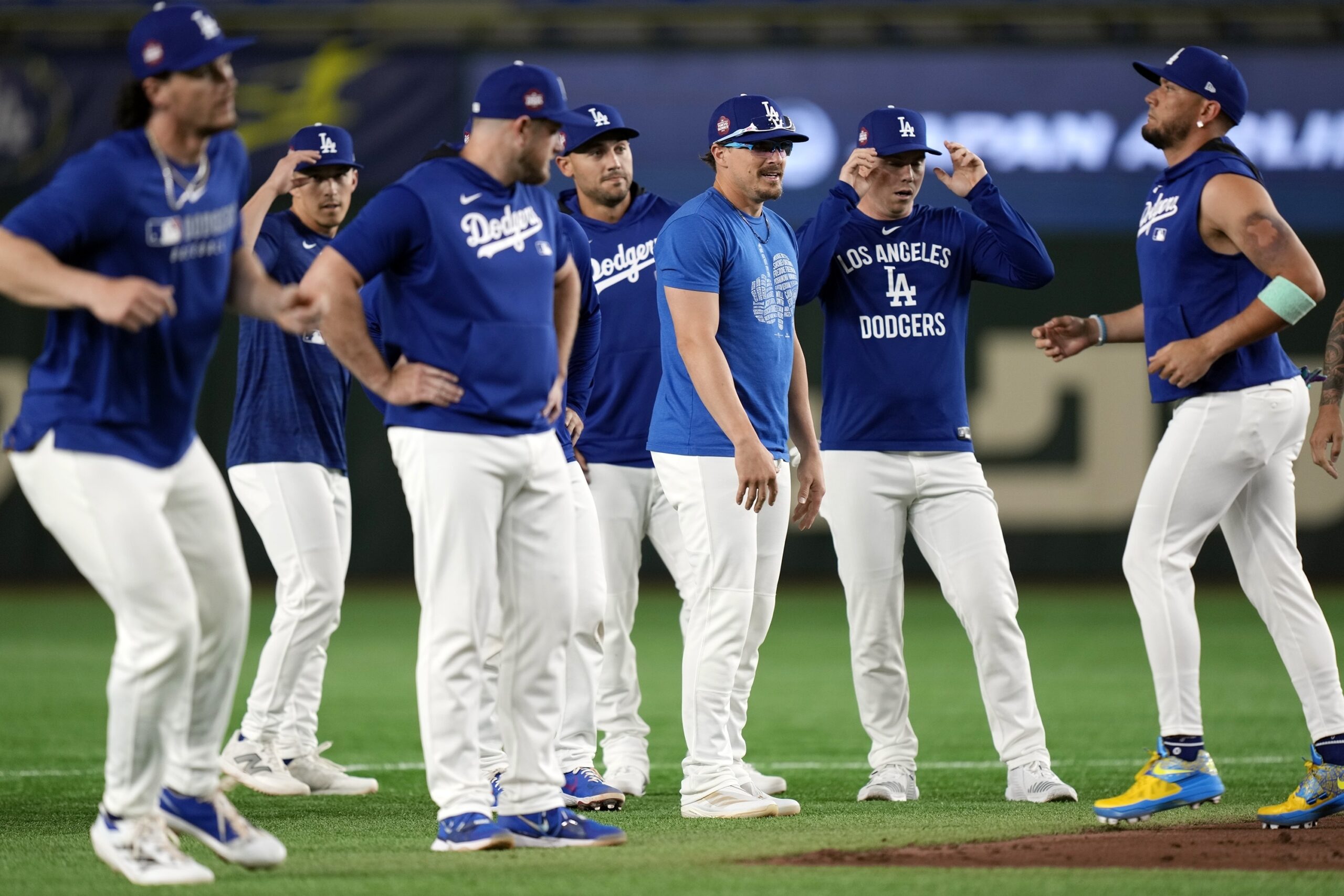 Dodgers players warm up during the official training, Friday, March...