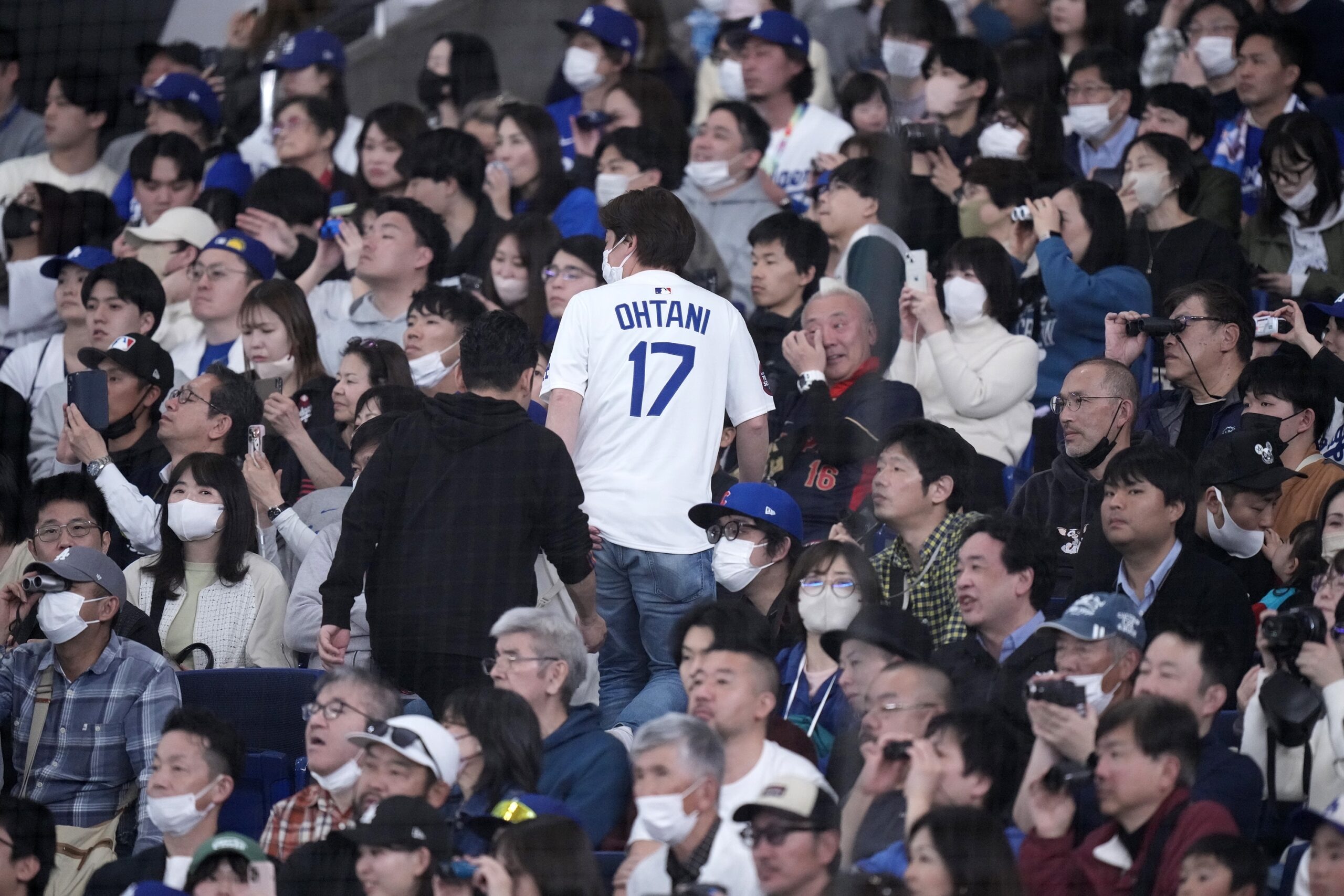 Fans watch the Dodgers work out on Friday, March 14,...