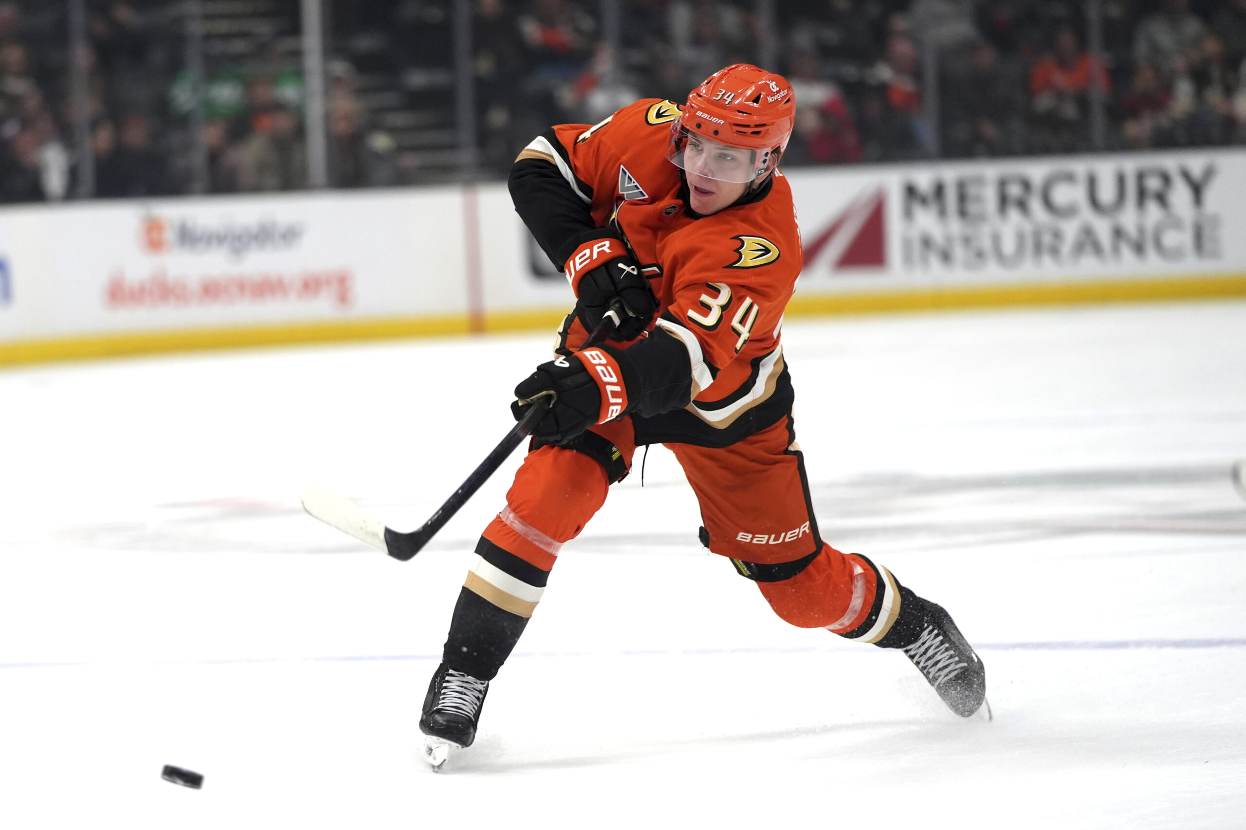 Ducks defenseman Pavel Mintyukov hits the puck during the first...