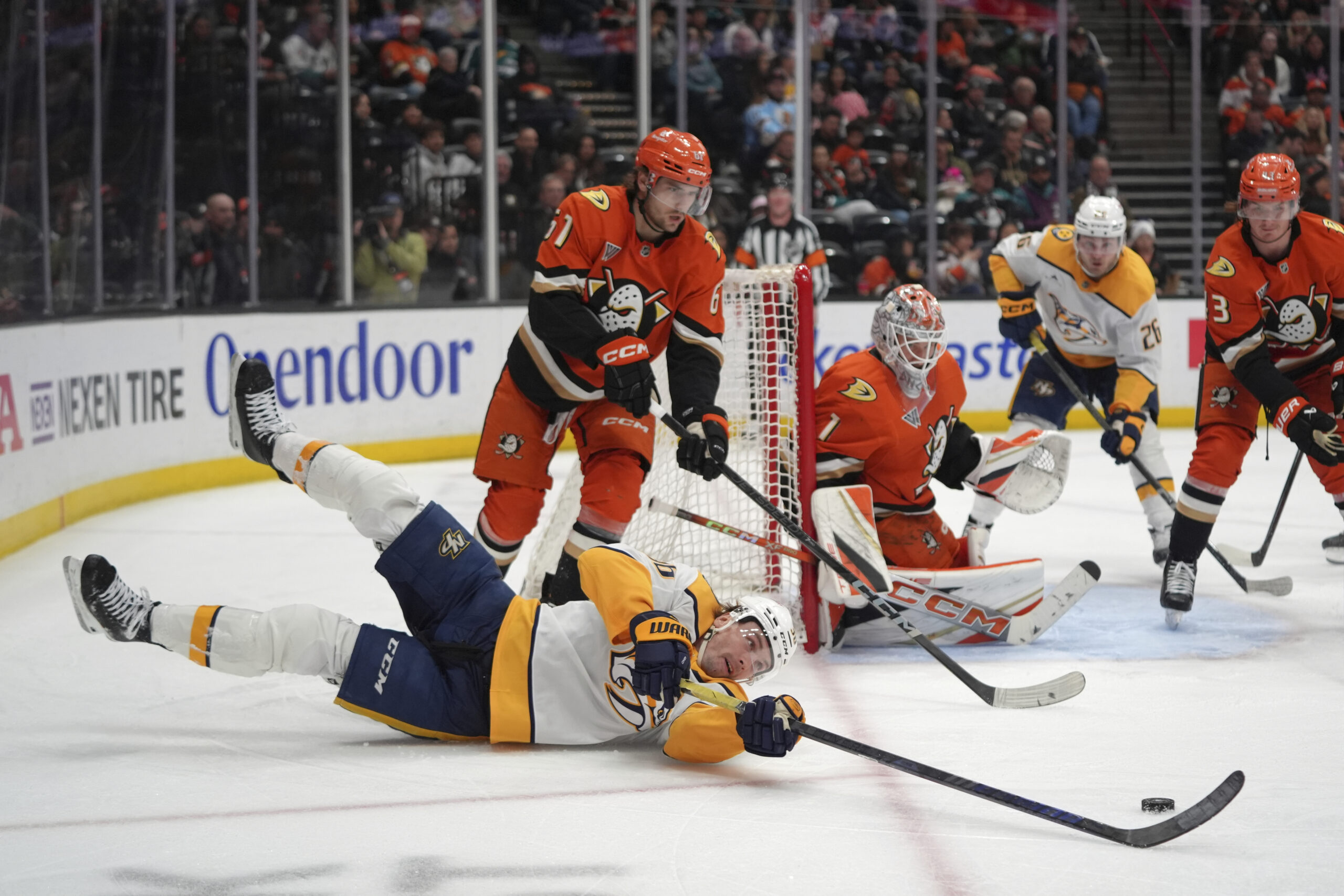 Nashville Predators left wing Cole Smith, front left, falls as...