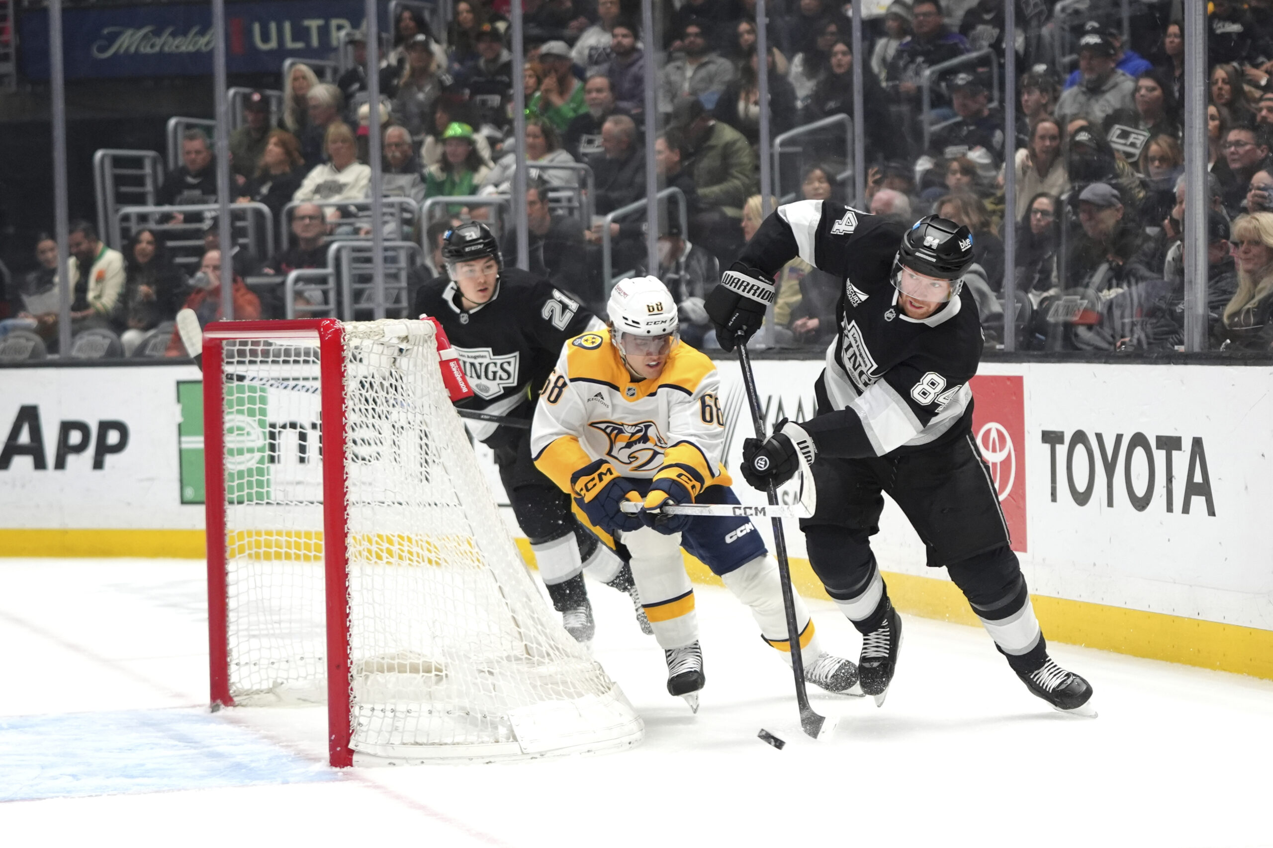 Kings defenseman Vladislav Gavrikov (84) moves the puck away from...