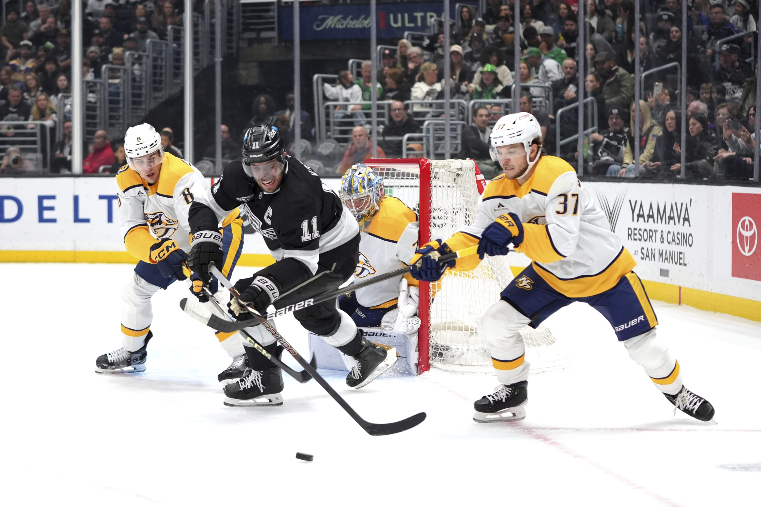 Kings center Anze Kopitar (11) is defended by Nashville Predators...