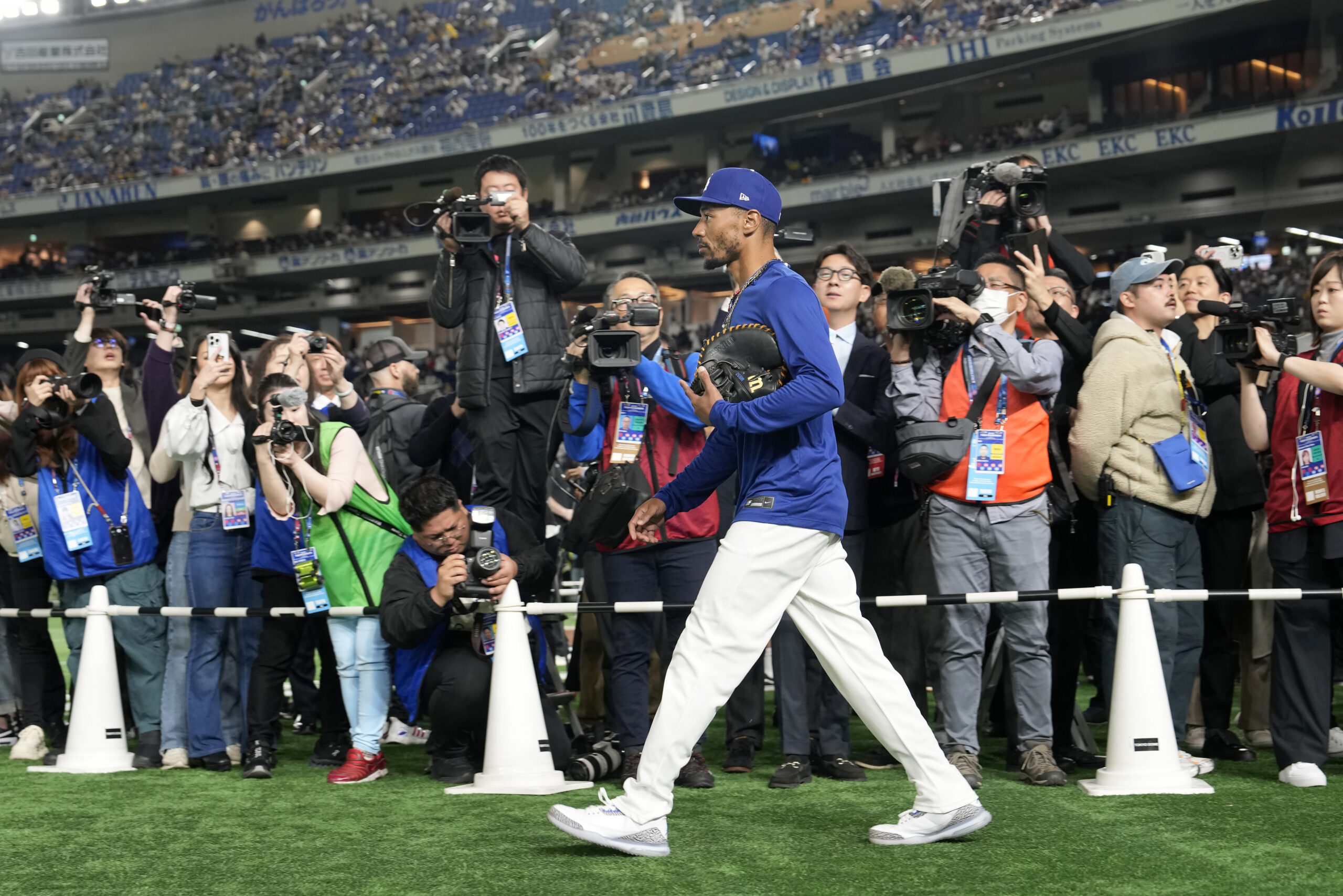 Dodgers star Mookie Betts walks onto the field before an...