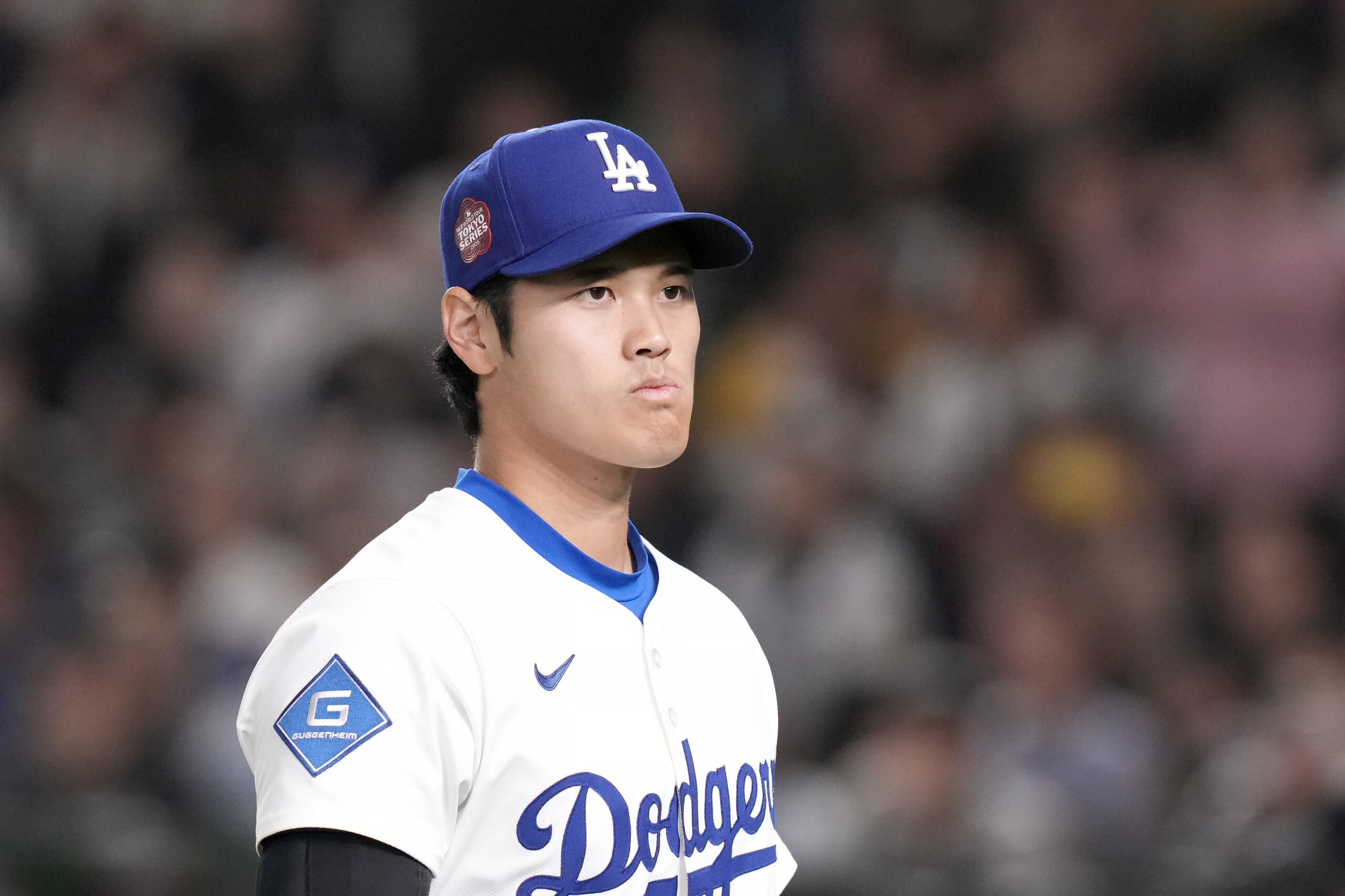 Dodgers star Shohei Ohtani walks on the field before an...