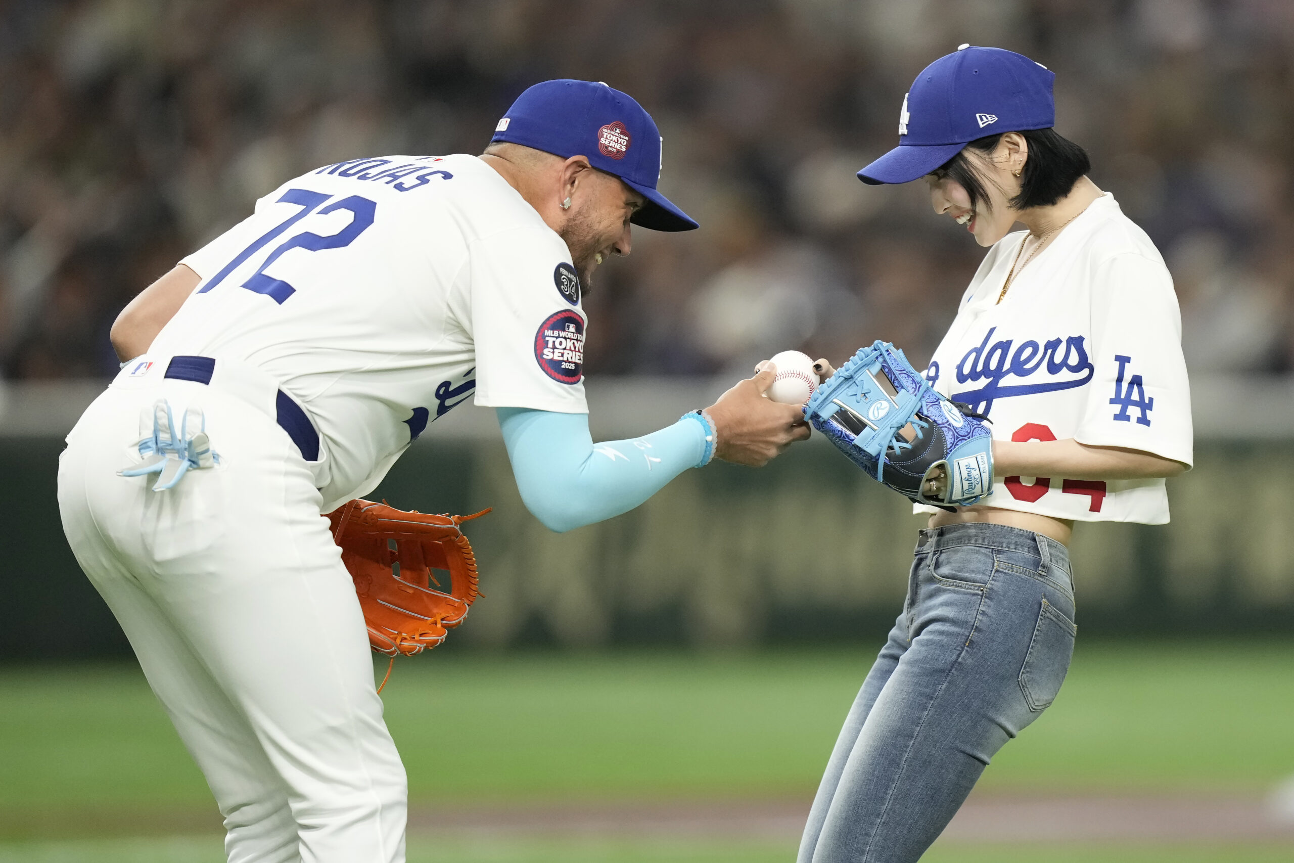 Dodgers infielder Miguel Rojas, left, greets a member of MISAMO,...