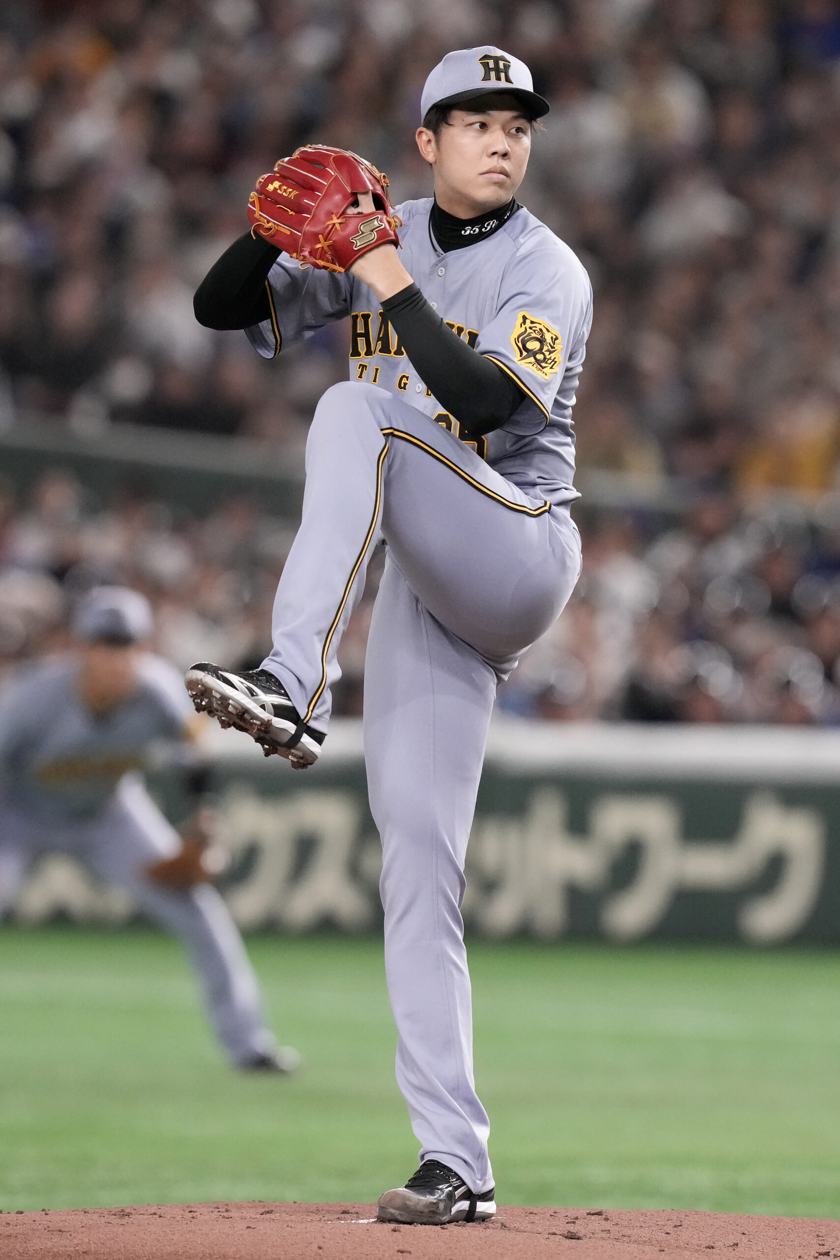 Hanshin Tigers pitcher Hiroto Saiki works against the Dodgers during...