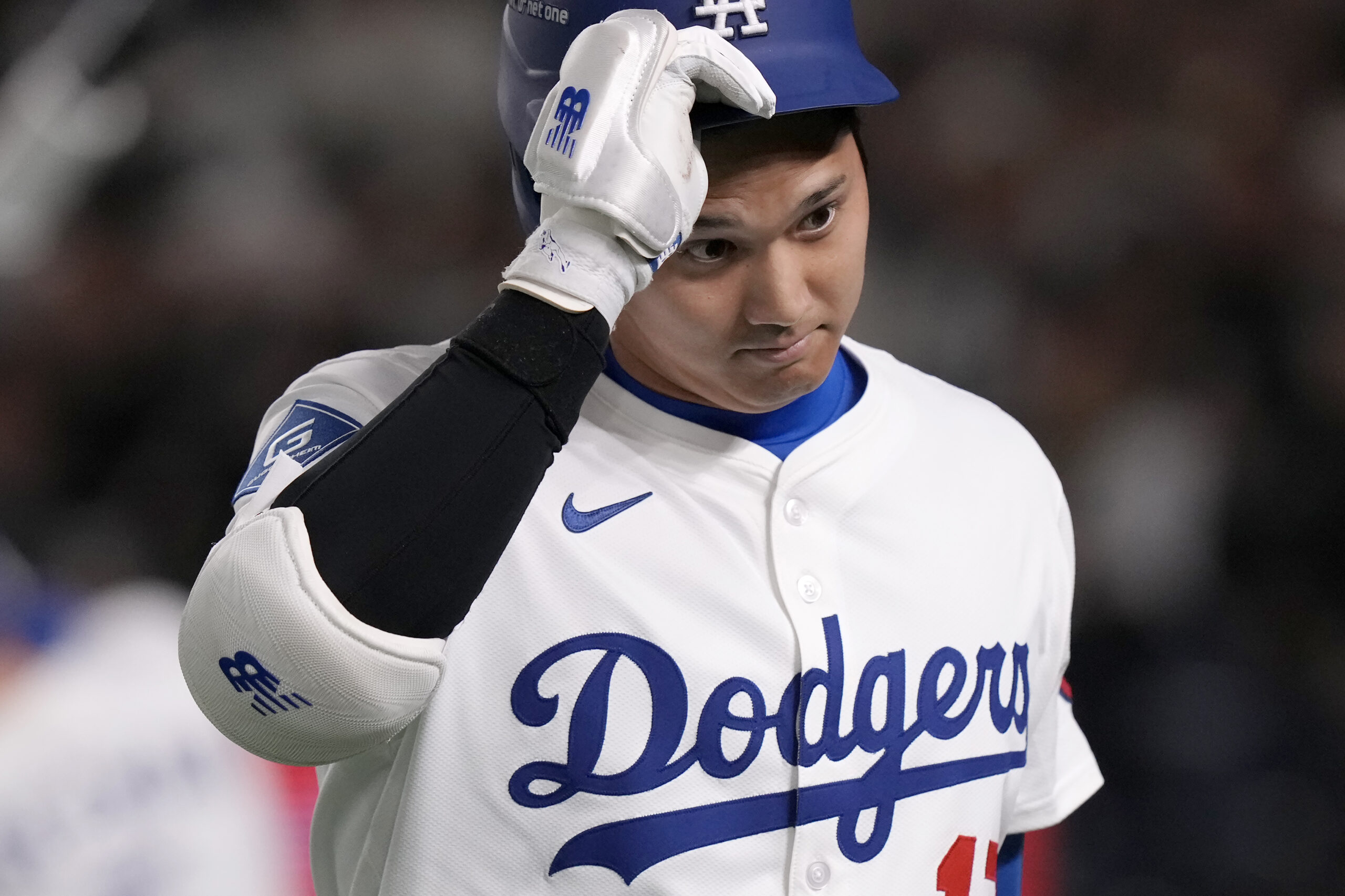 Dodgers star Shohei Ohtani walks back to the dugout after...