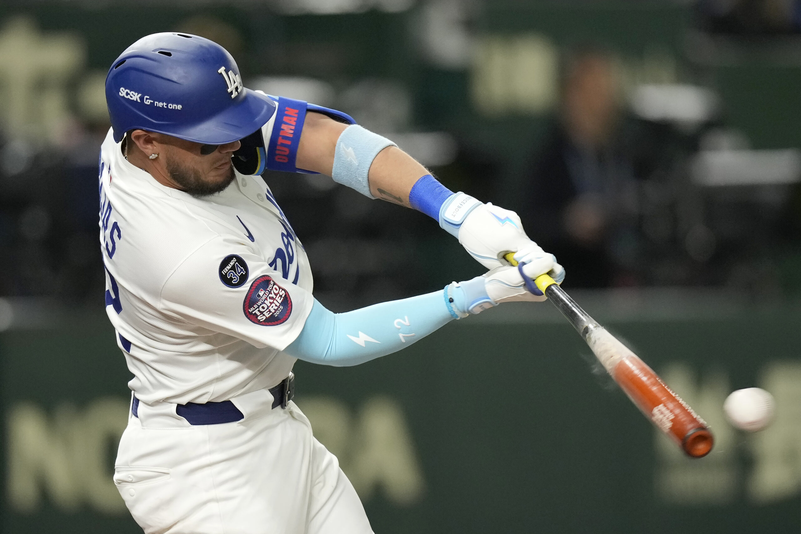 The Dodgers’ Miguel Rojas lines out against the Hanshin Tigers...