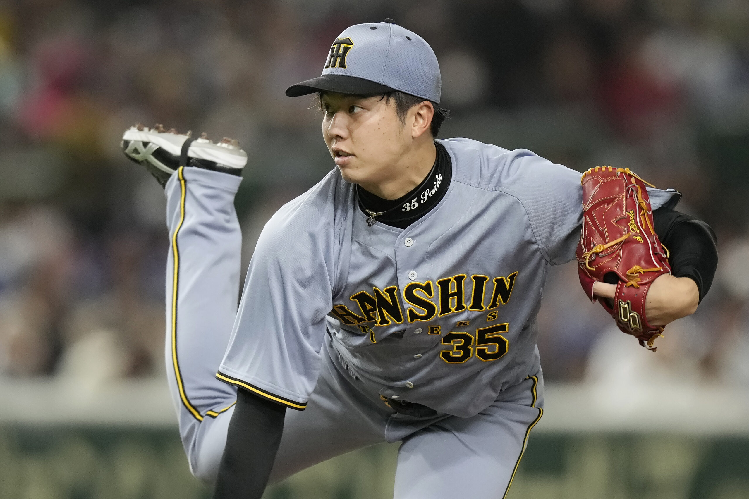 Hanshin Tigers pitcher Hiroto Saiki works against the Dodgers during...