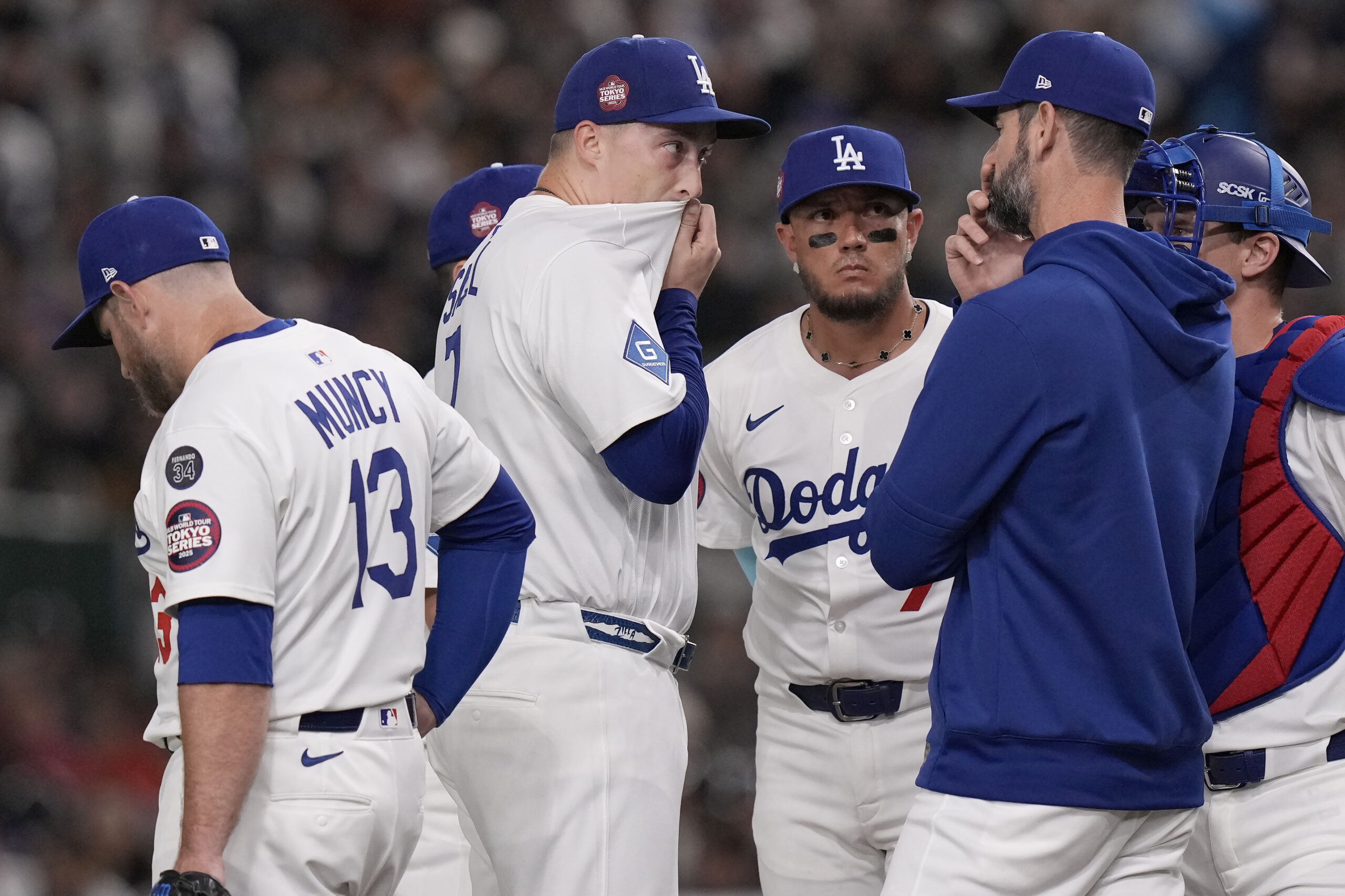 Dodgers starting pitcher Blake Snell, middle, reacts during a mound...