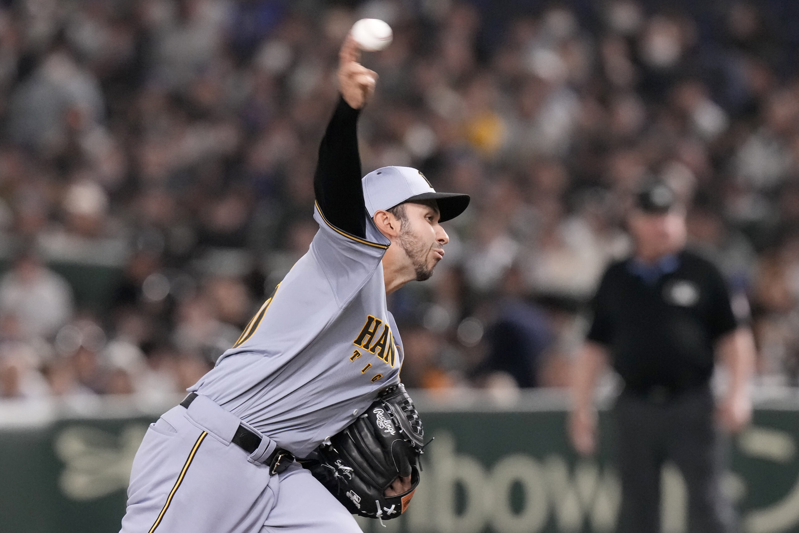 Hanshin Tigers pitcher Javy Guerra works against the Dodgers during...