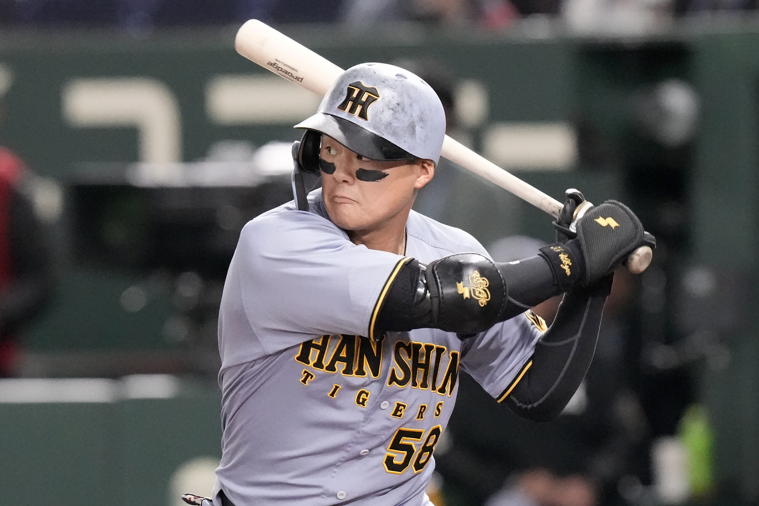 The Hanshin Tigers’ Ukyo Maegawa singles against the Dodgers during...