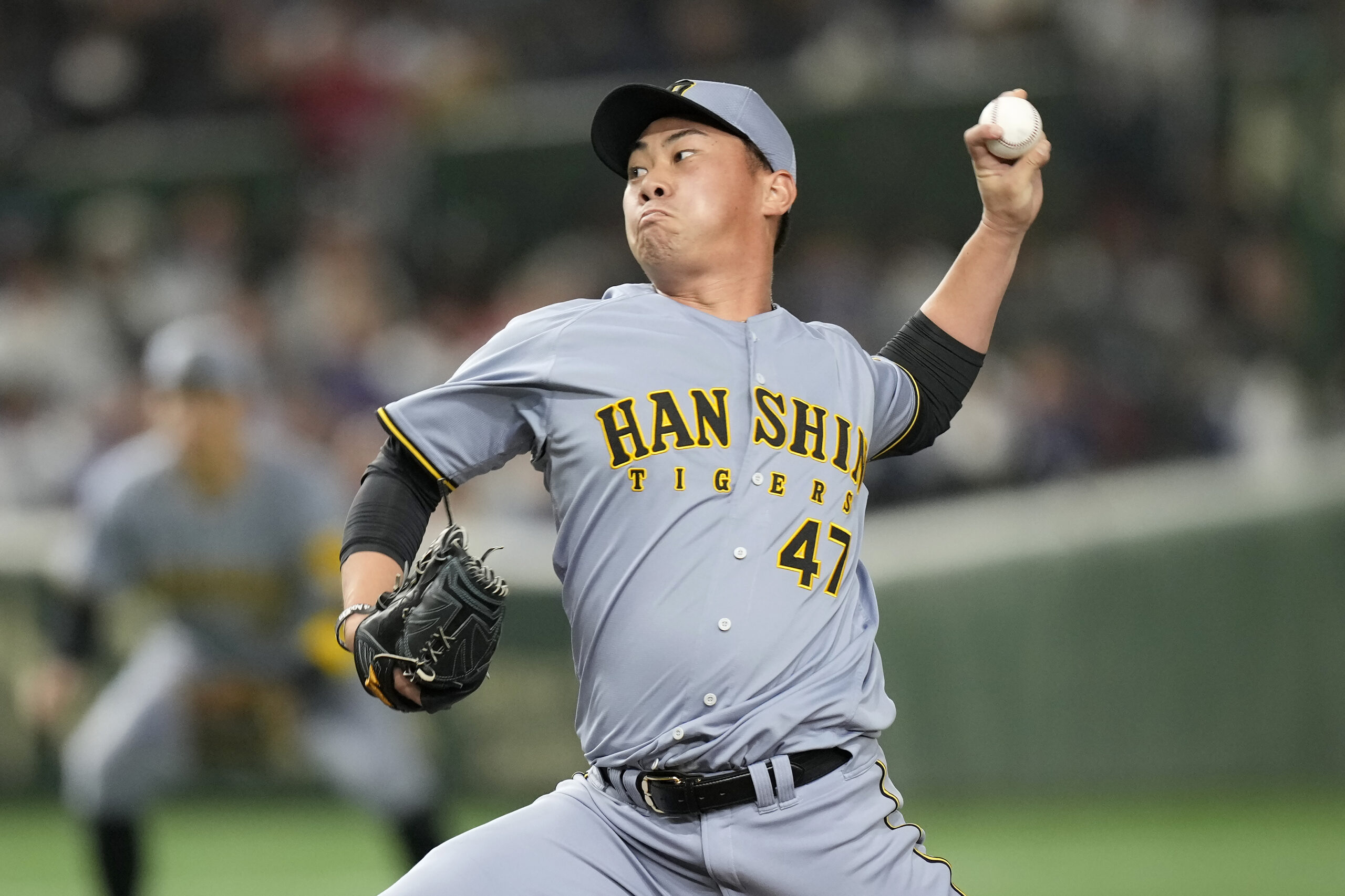 Hanshin Tigers pitcher Takuma Kirishiki works against the Dodgers during...